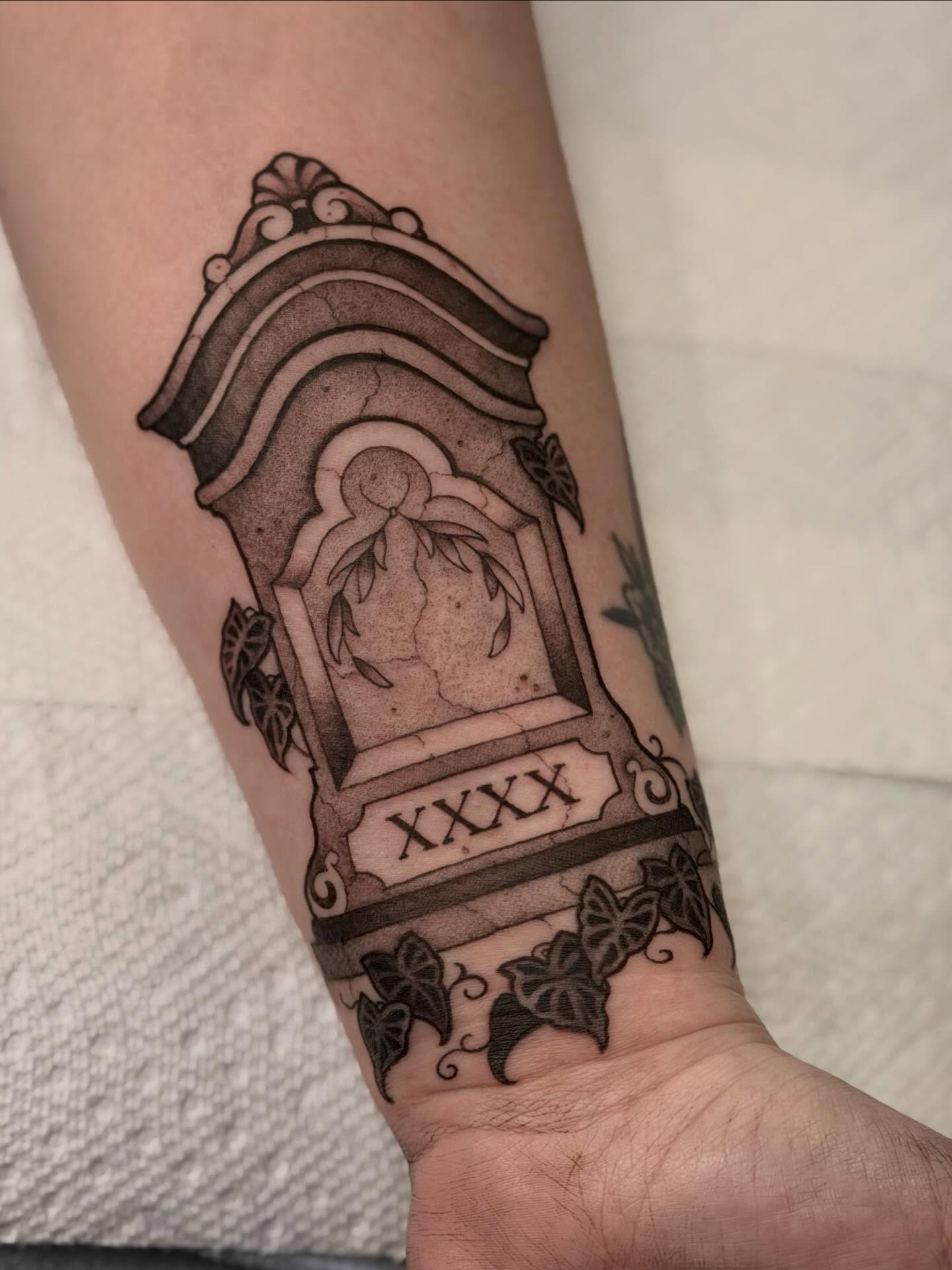Gravestone black and grey tattoo on the forearm by English Cousins, Nashville, Tennessee