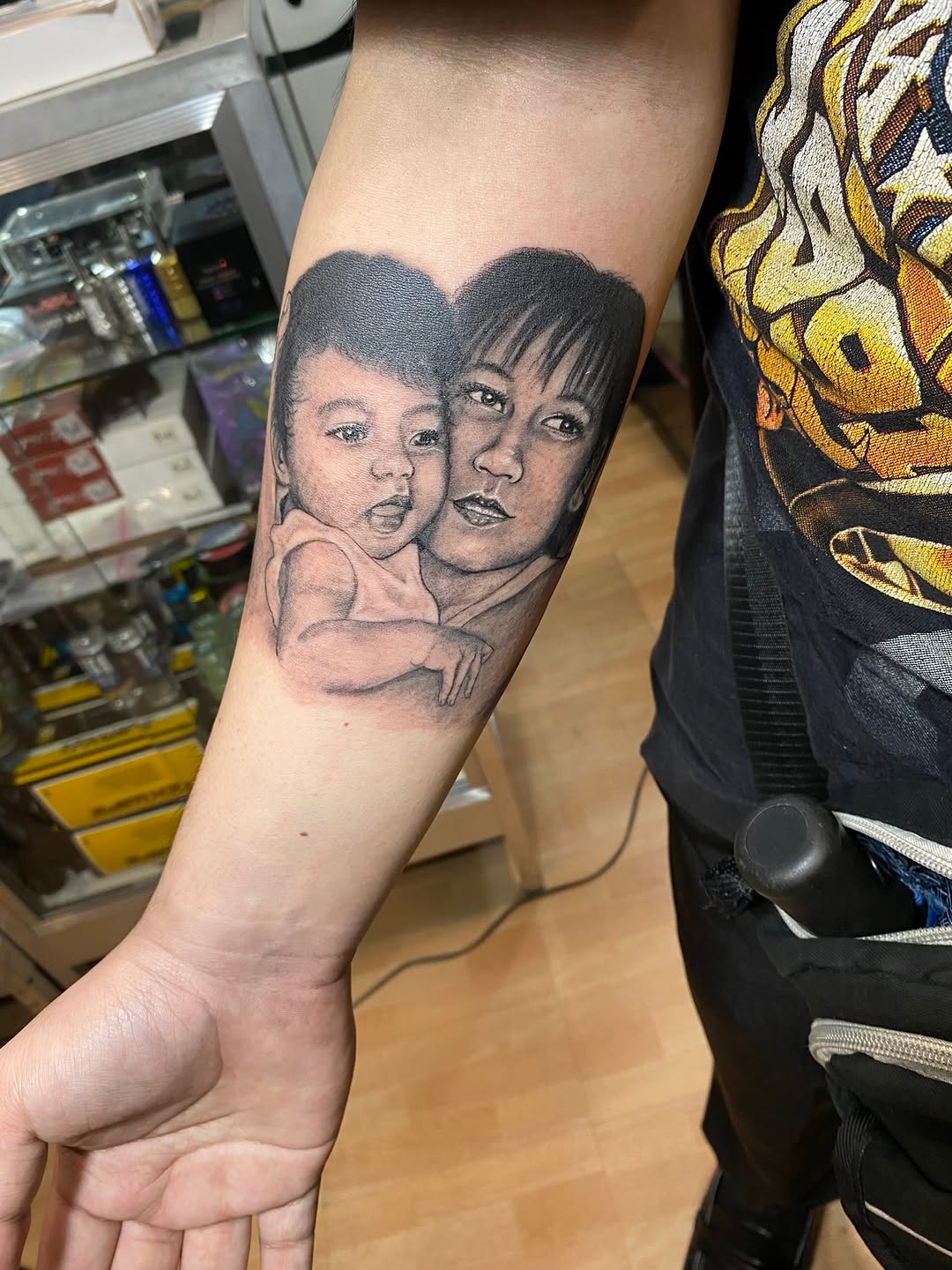 Mother and child portrait tattoo on the forearm by Ferds Villanueva