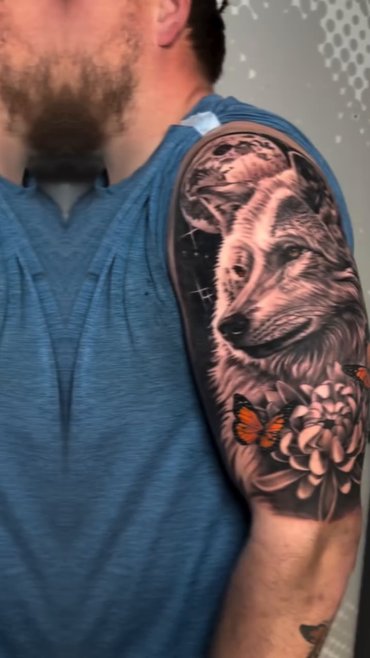 Wolf and flowers realism tattoo by Charlotte Tattoo Artist