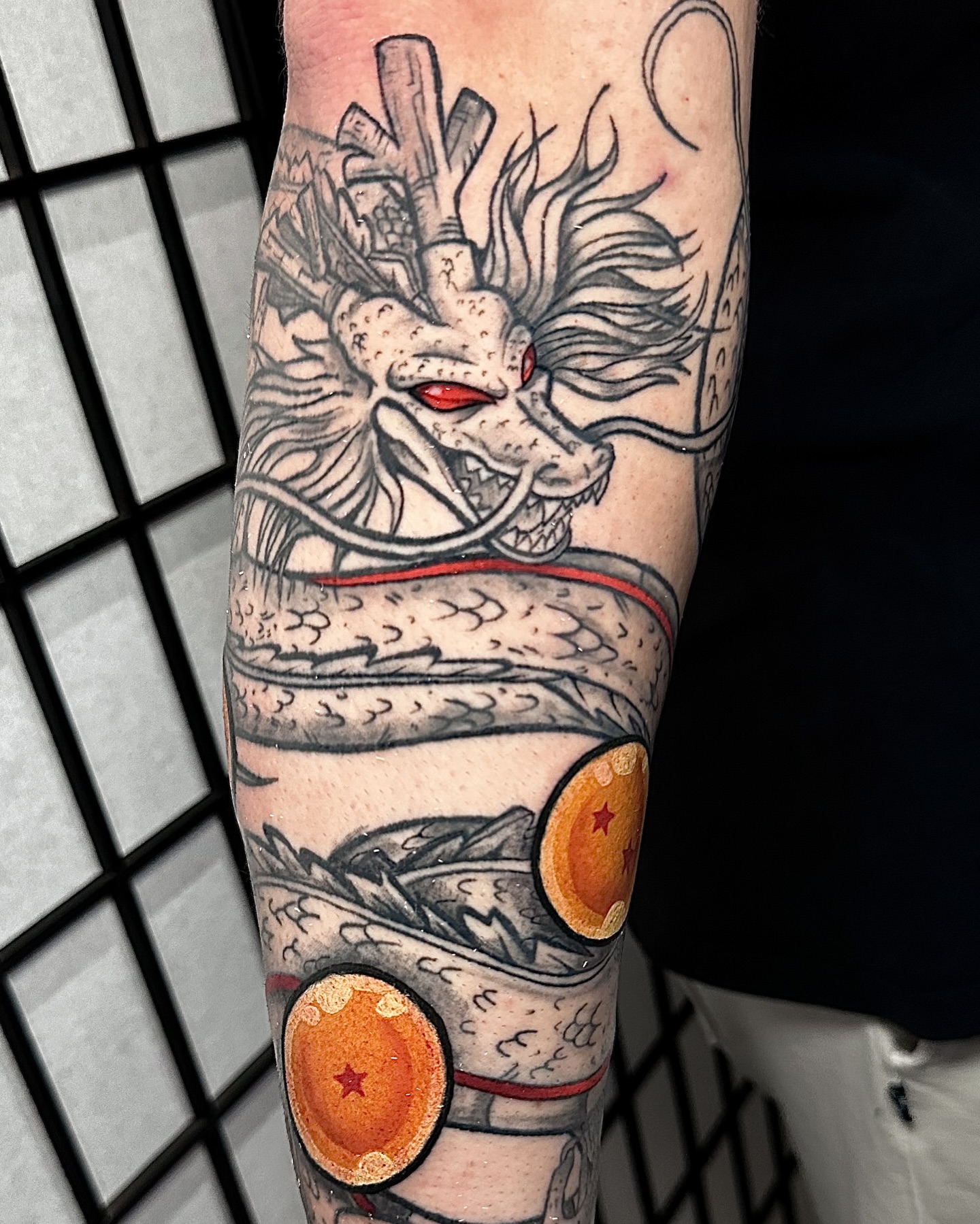 Dragon and orbs American traditional tattoo on the forearm by Taylin Johnson- Illustrative Blackwork, Columbus, Ohio