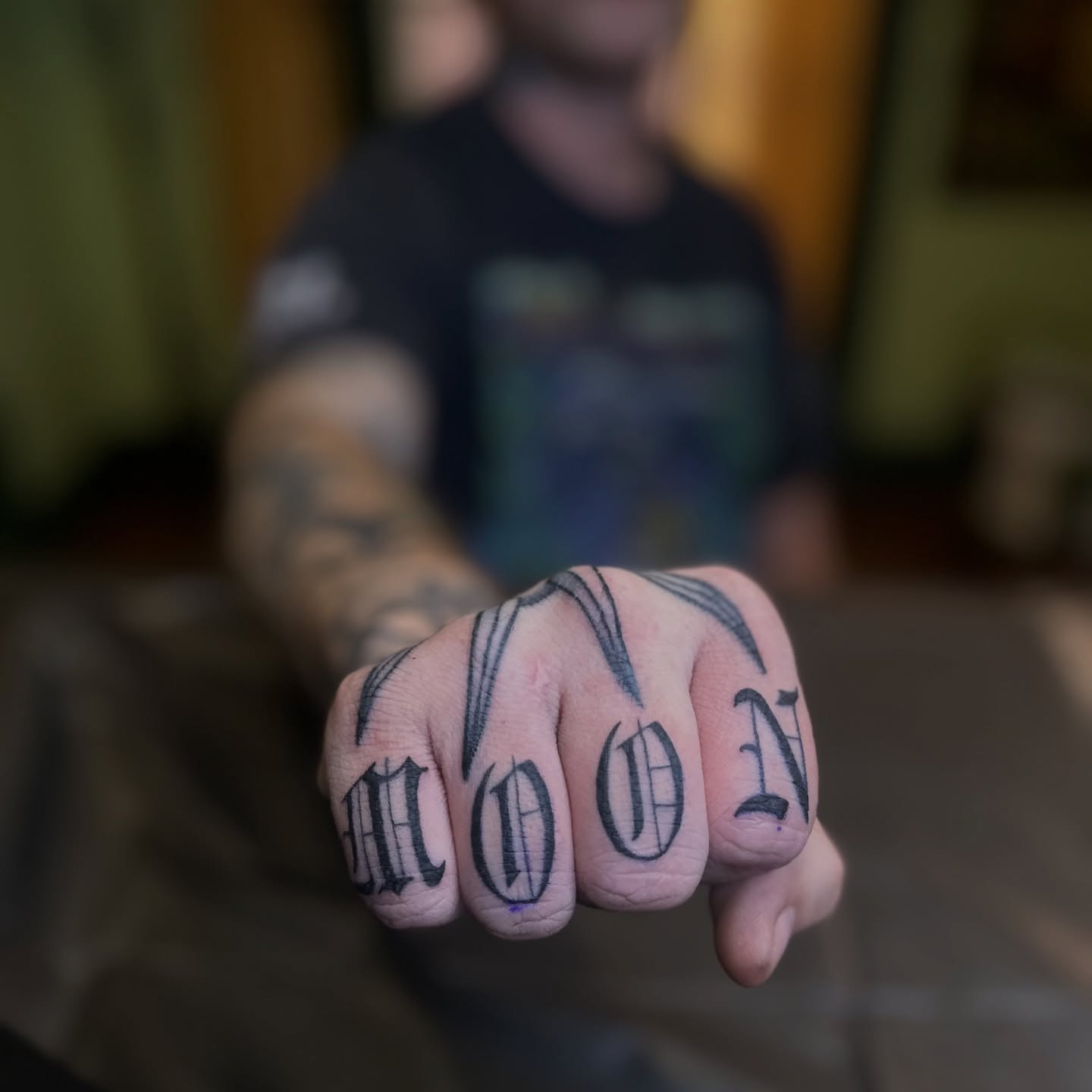 MOON lettering script tattoo on the hand by Brieana Smith