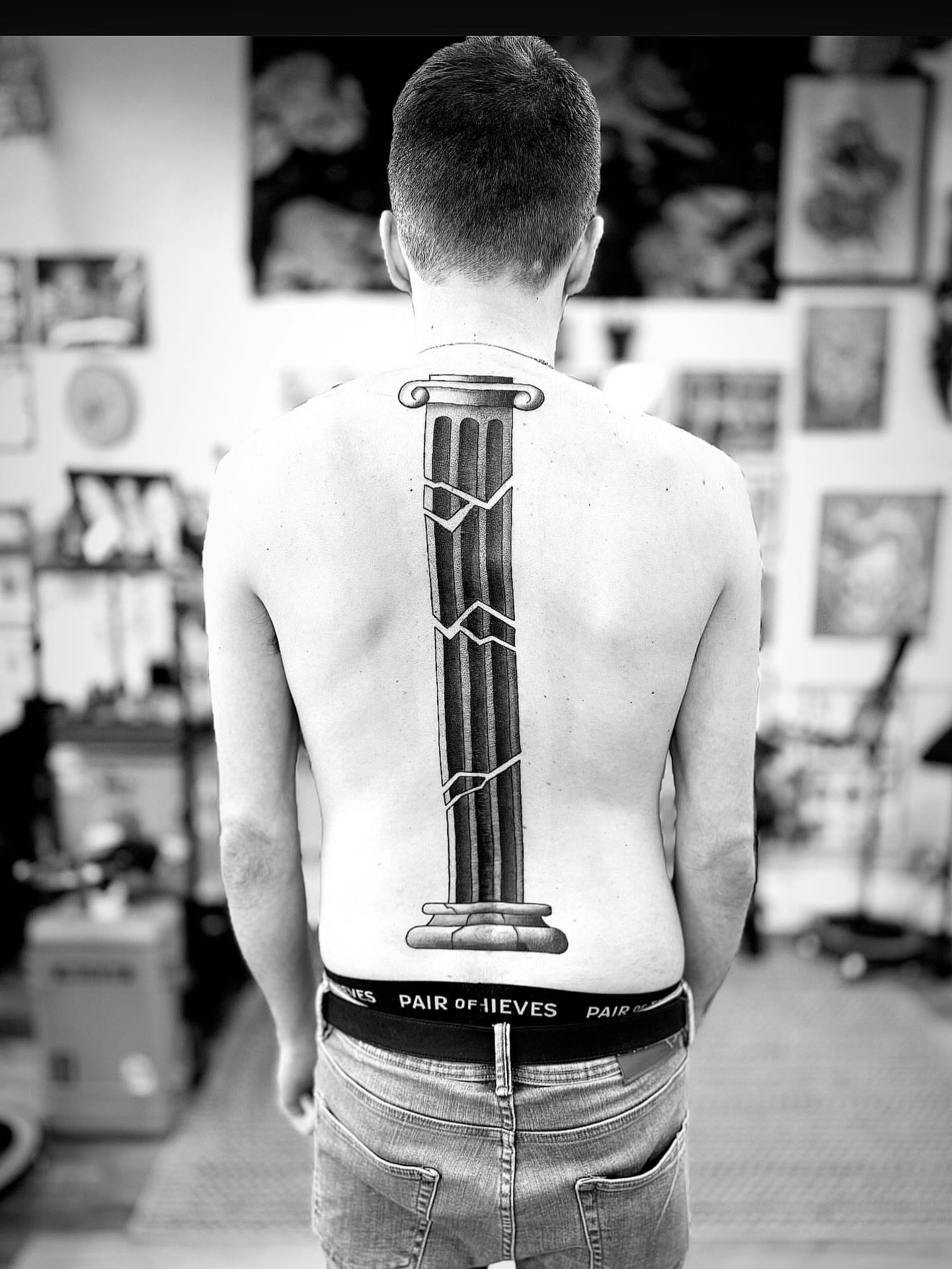 Column black and grey tattoo on the back by Rigo Vargas