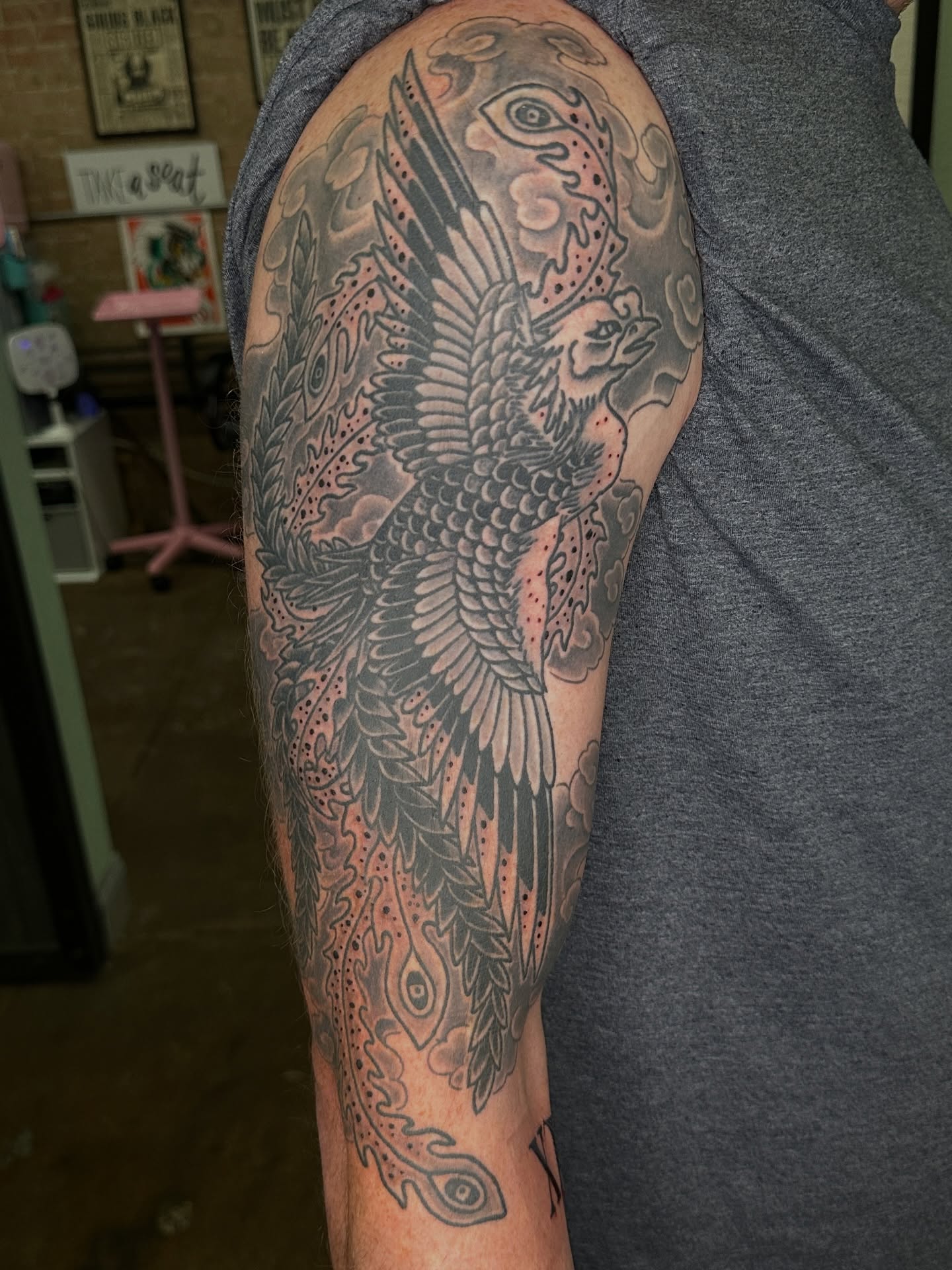 Phoenix black and grey tattoo on the upper arm by Jared, Addison, Texas