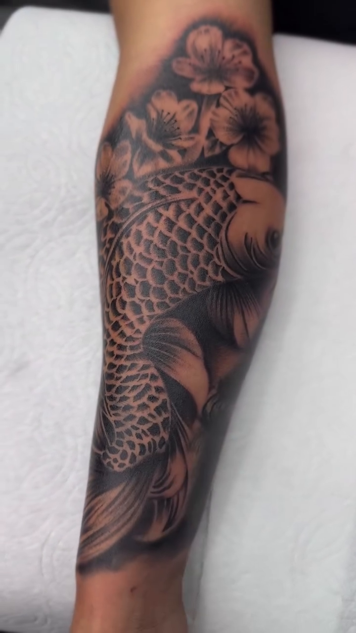 Koi fish with flowers japanese irezumi tattoo by Alex Romero
