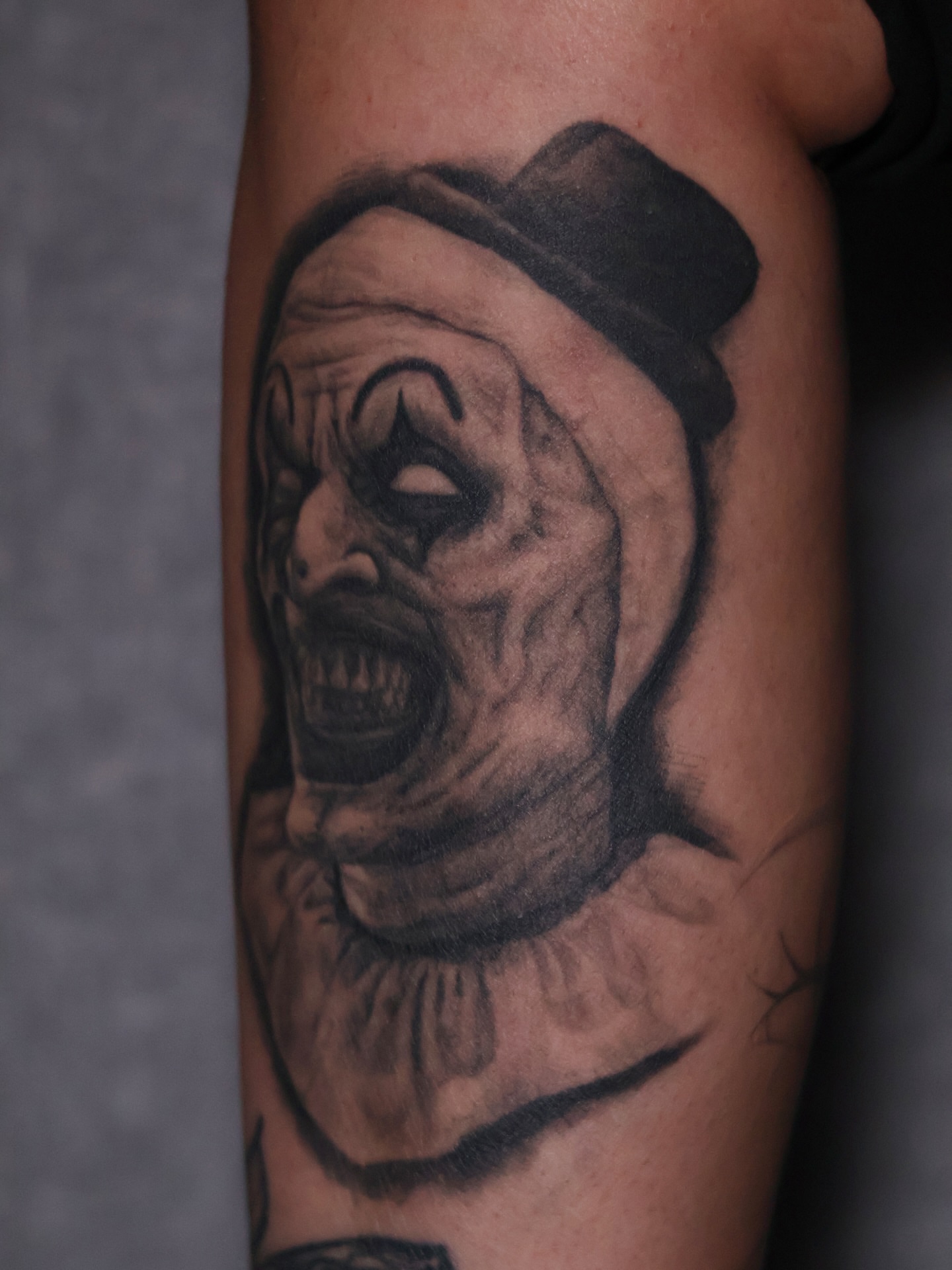 Clown realism tattoo on the forearm by Júlia Sorrino