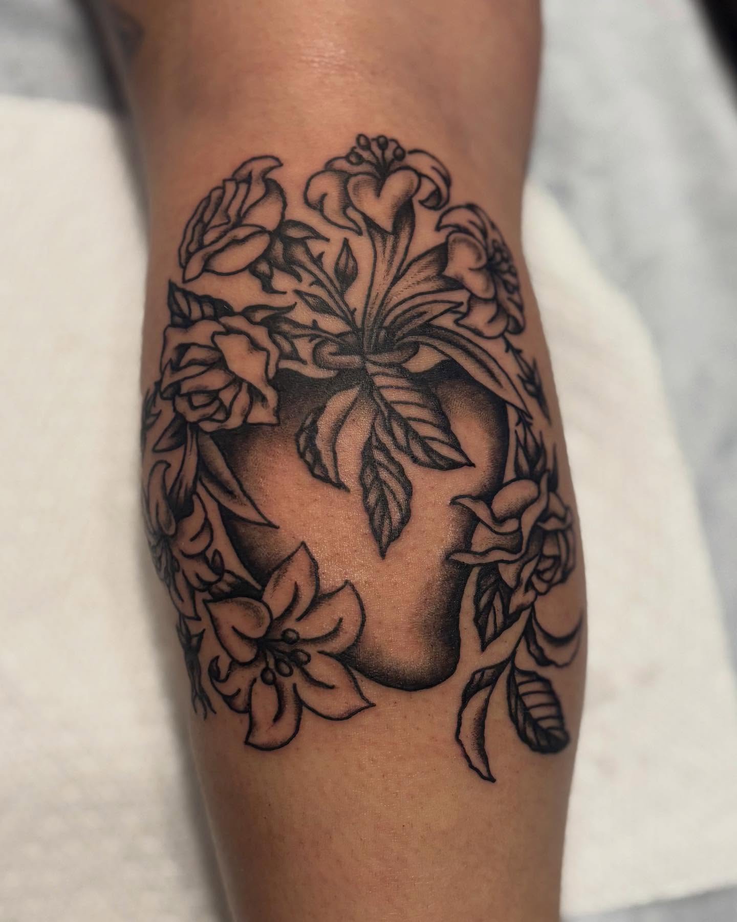 Flower bouquet black and grey tattoo on the forearm by Tia Cave