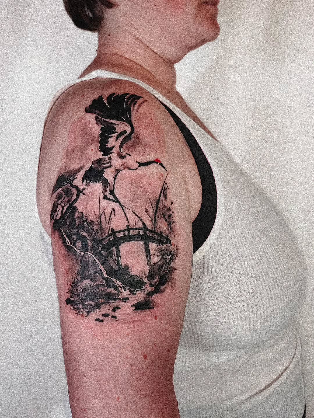 Bird and bridge realism tattoo on the upper arm by 𝗔𝗟𝗘𝗫 𝗣𝗥𝗘𝗤𝗨𝗘𝗟 𝗧𝗔𝗧𝗧𝗢𝗢𝗦 𝗖𝗛𝗜𝗖𝗔𝗚𝗢 ™, Chicago, Illinois