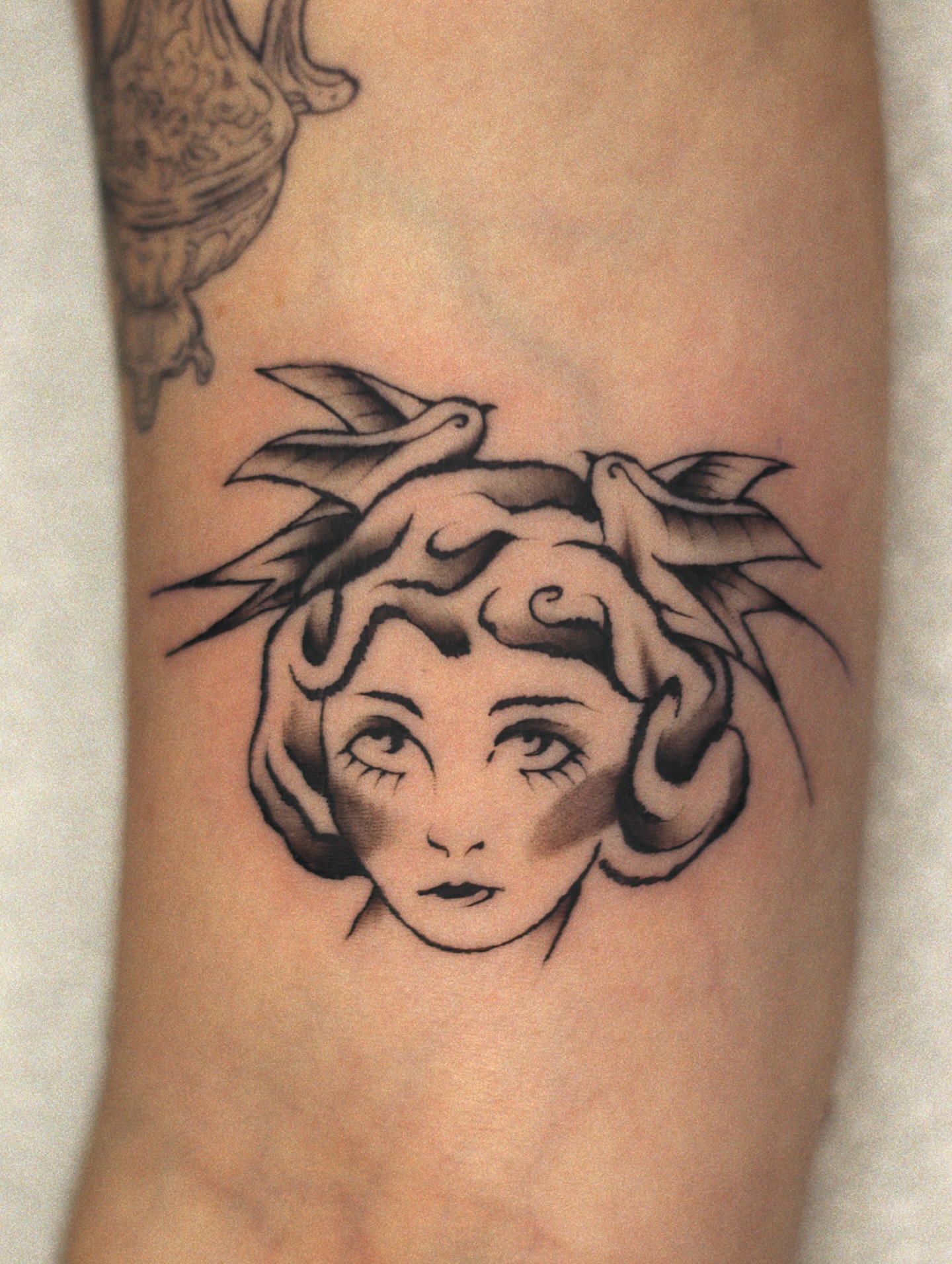 Woman's head black and grey tattoo on the forearm by Nik Checots
