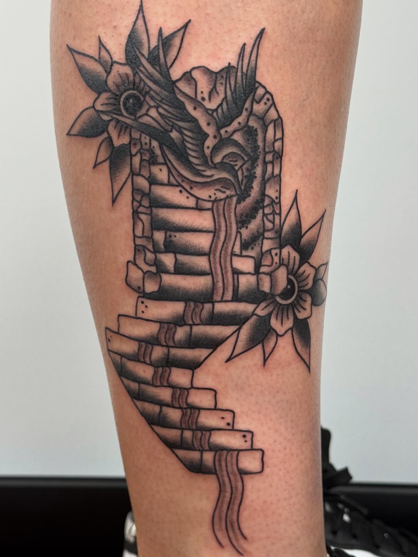 Dragon and flowers black and grey tattoo on the forearm by π©πͺπ¬