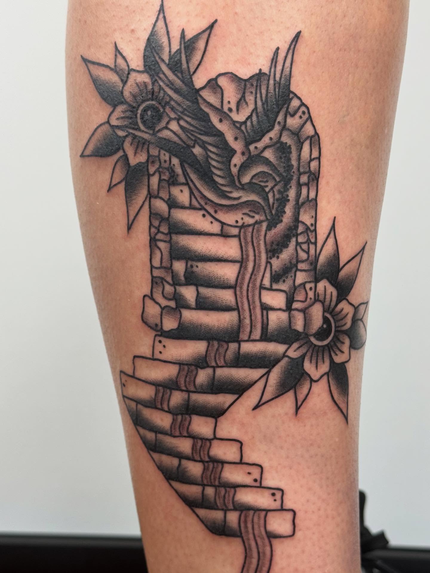 Dragon and flowers American traditional tattoo on the forearm by π©πͺπ¬