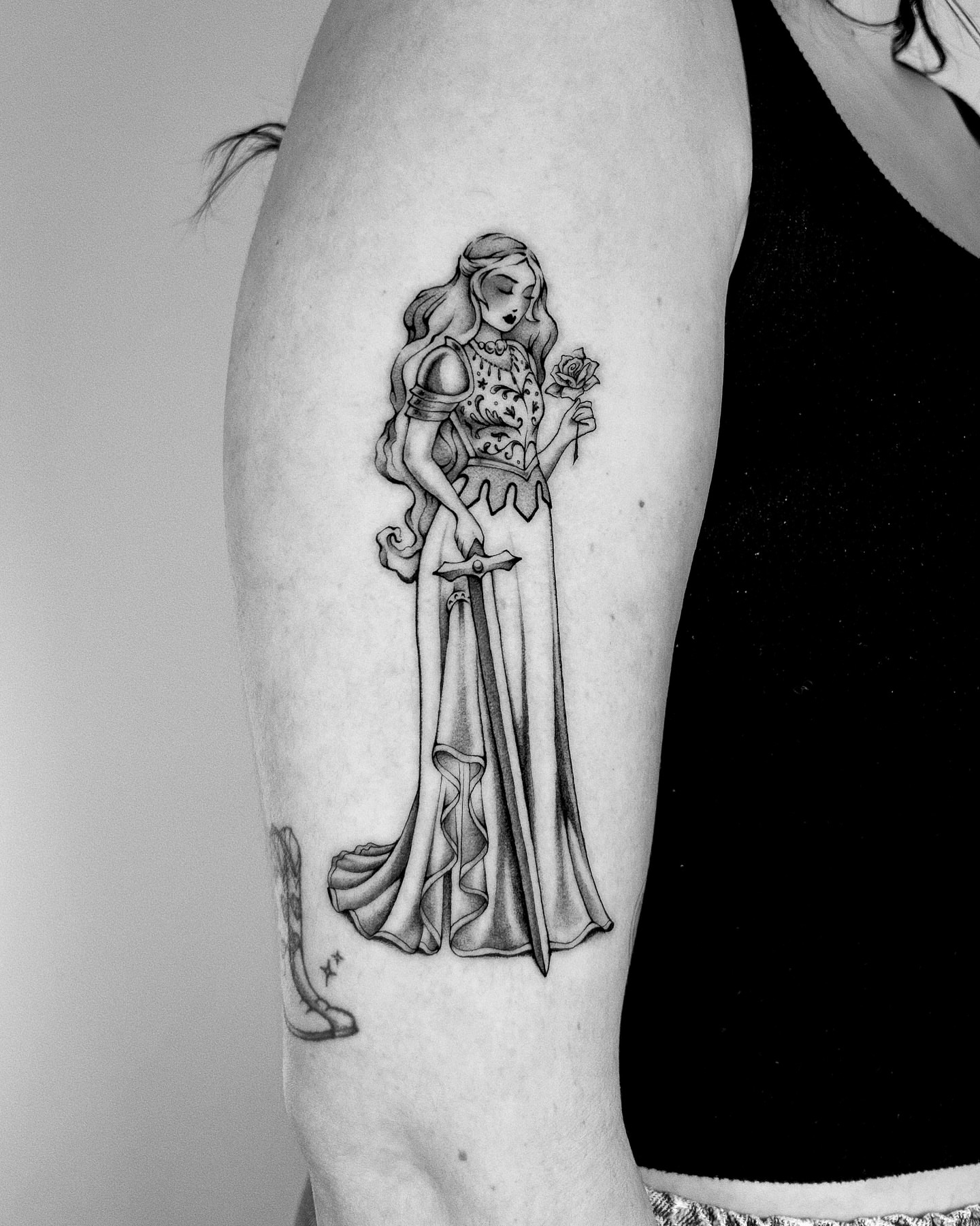 Woman with rose realism tattoo on the forearm by Montana Chambers