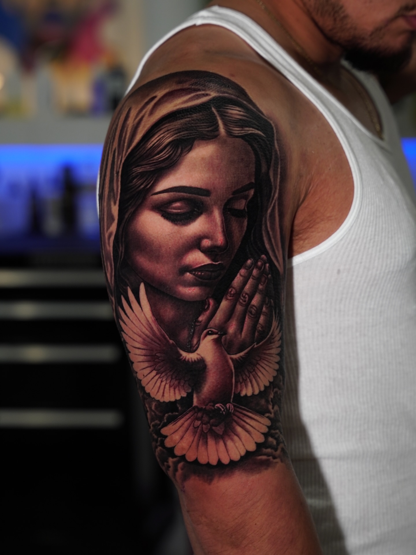 Praying woman with dove realism tattoo on the forearm by Dallas tattoo artist