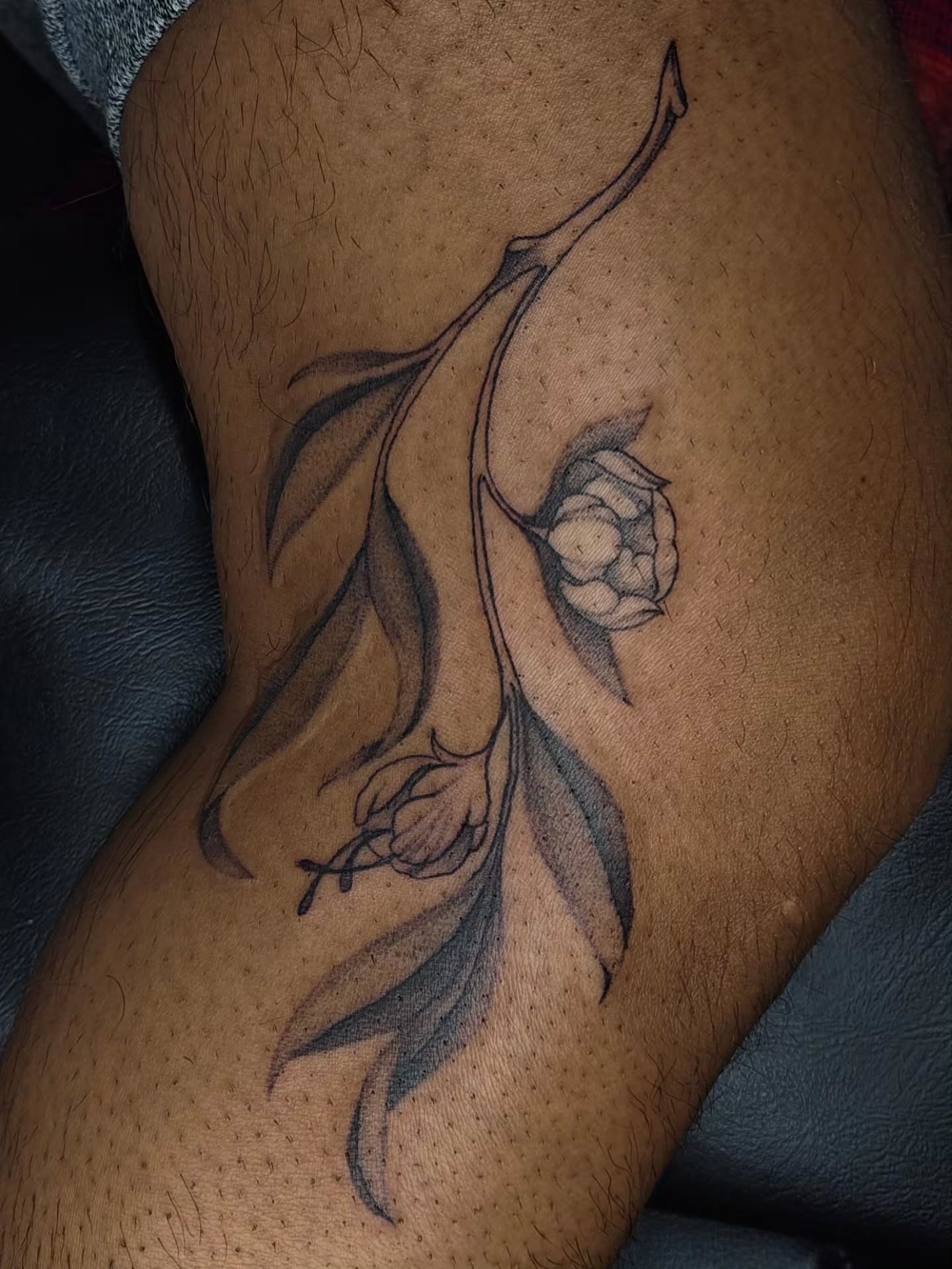 Flower branch black and grey tattoo on the thigh by Luna 🌙