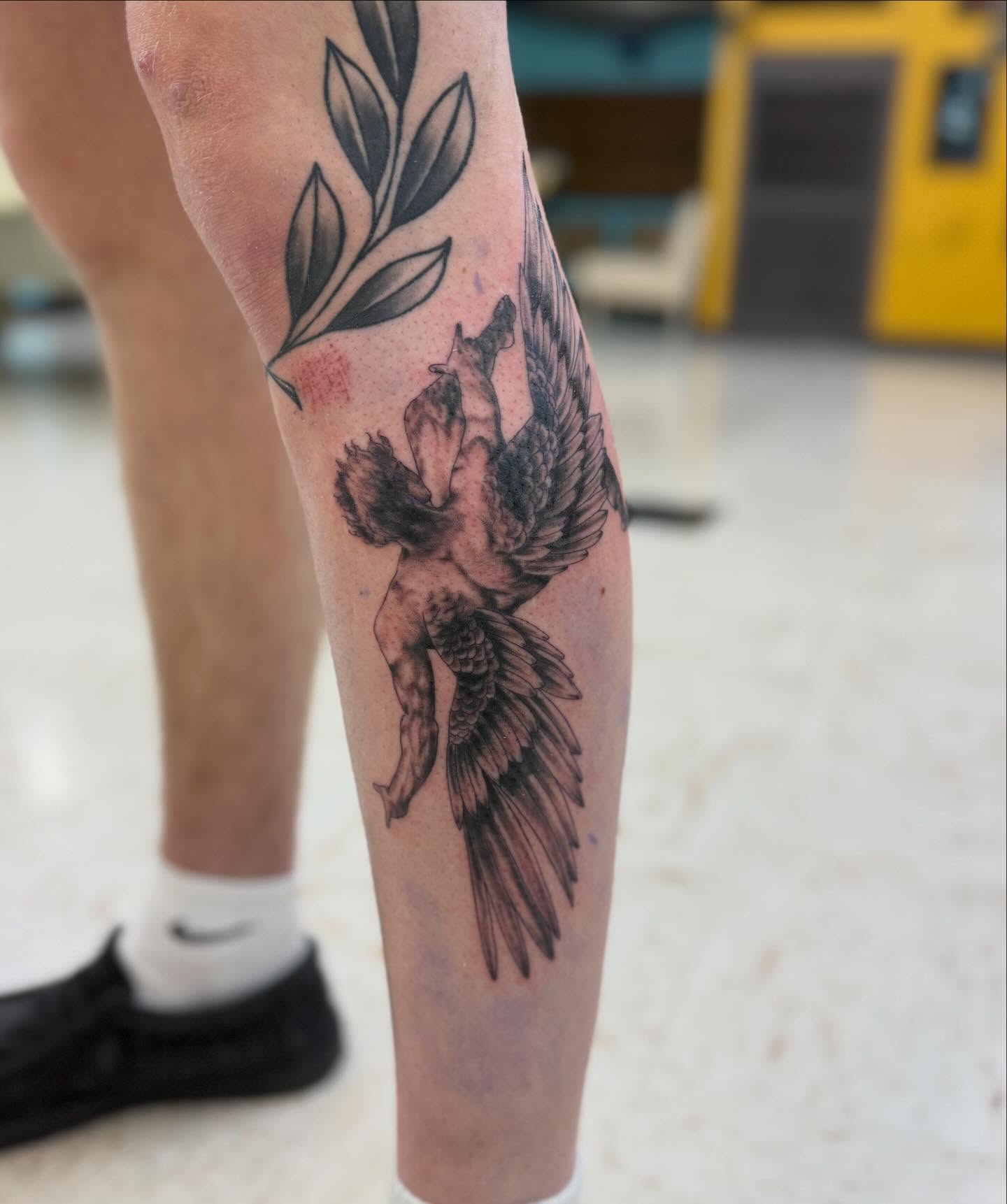 Angel with wings black and grey tattoo on the calf by Levi Sawdon, Everett, Washington
