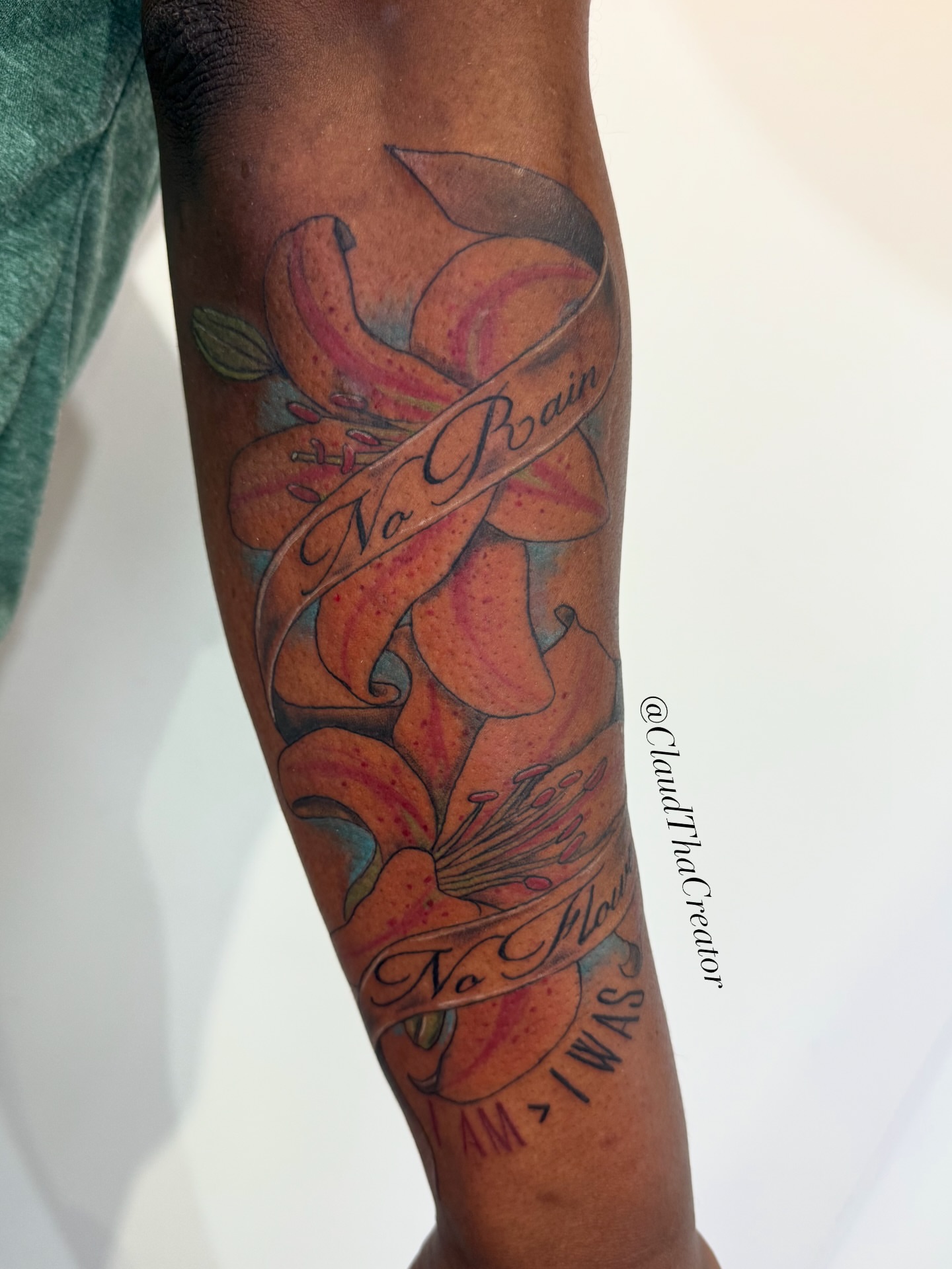 Lily and ribbon American traditional tattoo on the forearm by claud, Atlanta, Georgia