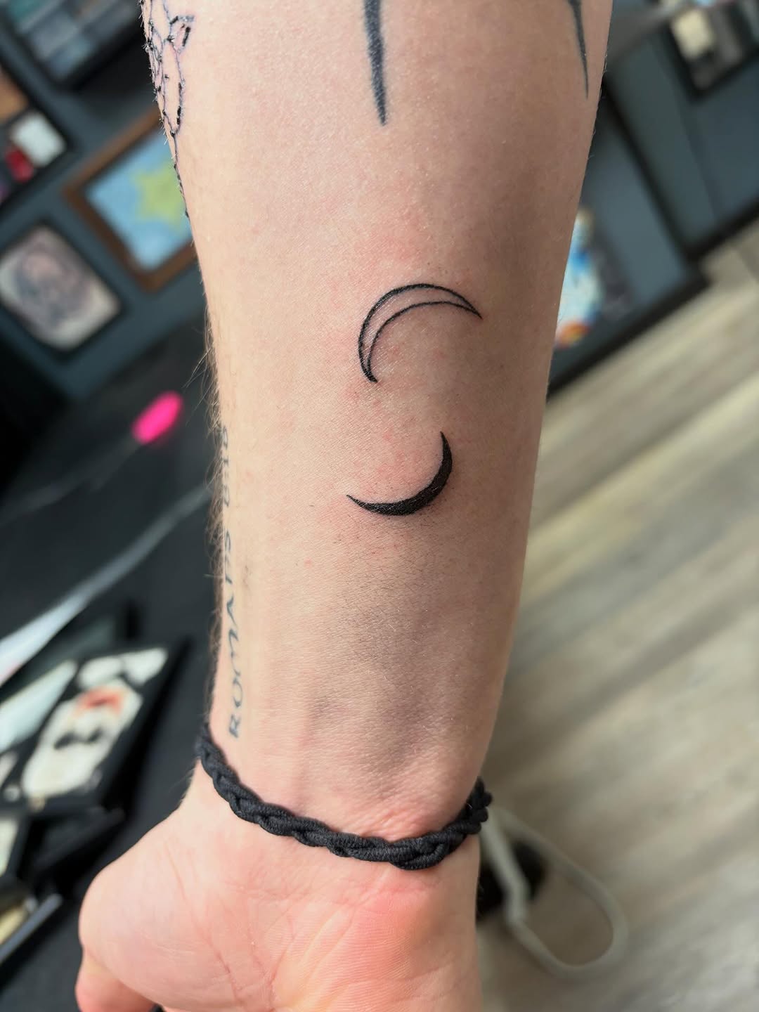 Two crescent moons minimalist tattoo on the forearm by Madison
