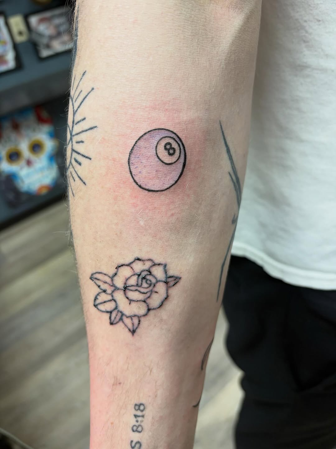 8 ball and rose minimalist tattoo on the forearm by Madison