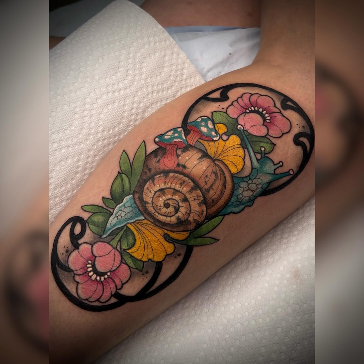 Snail and floral American traditional tattoo on the forearm by Alyssa Deeghan