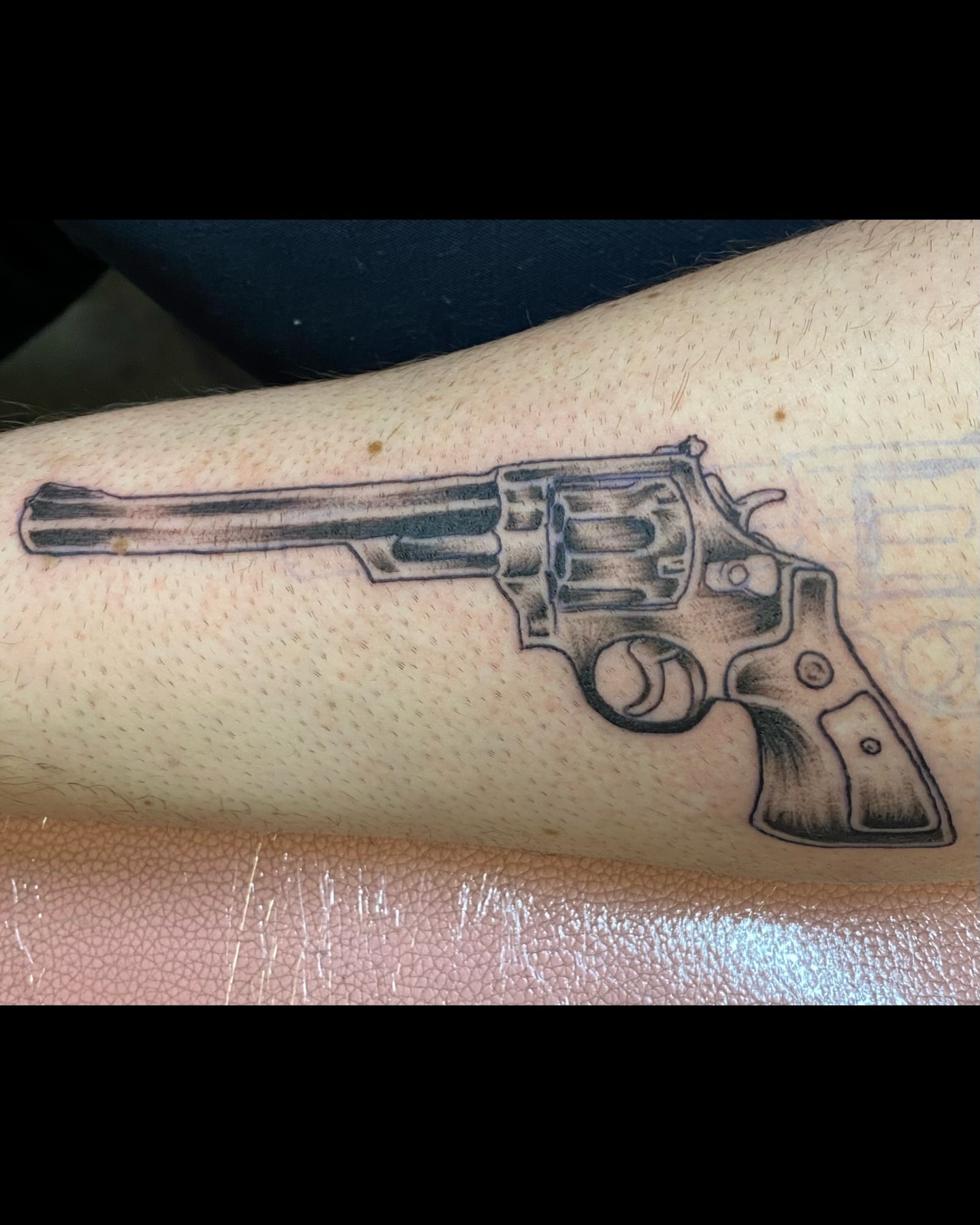 Revolver black and grey tattoo on the forearm by Mack ๐ Utah Tattoos