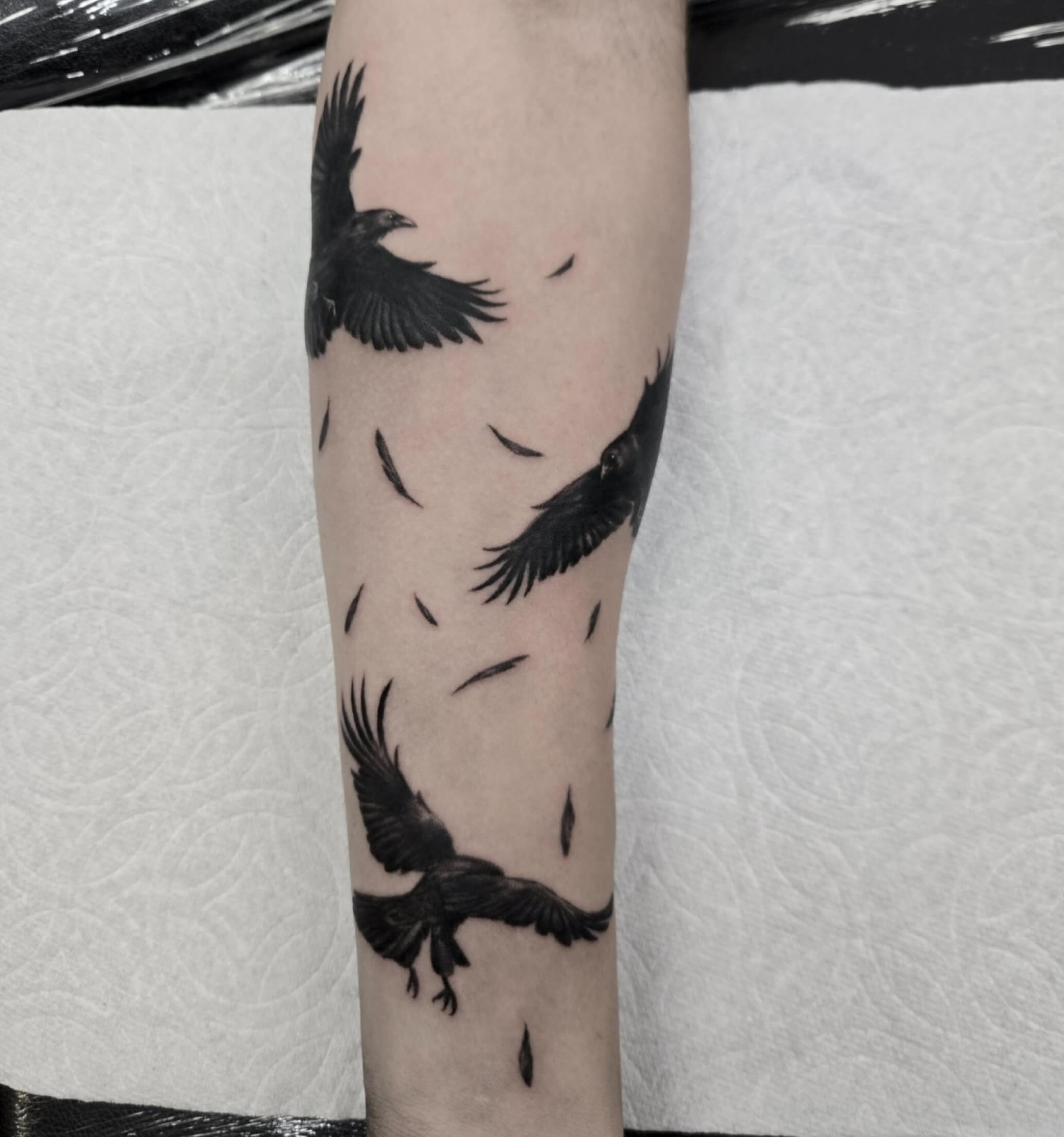 Flock of crows realism tattoo on the forearm by ๐