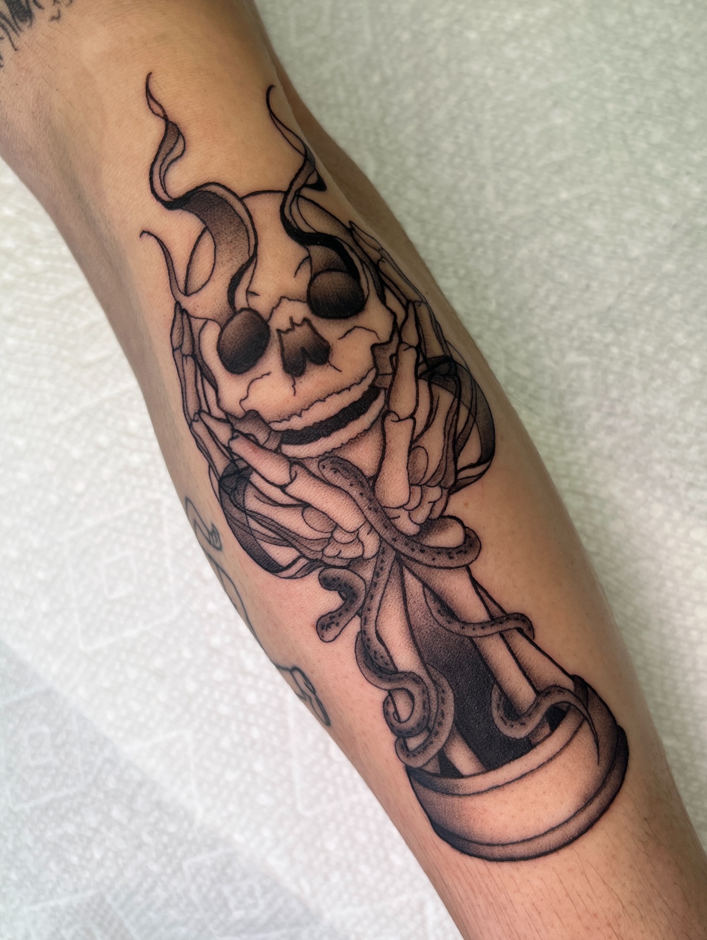 Skull and snake realism tattoo on the forearm by Blair Schwartz, Asbury Park, New Jersey
