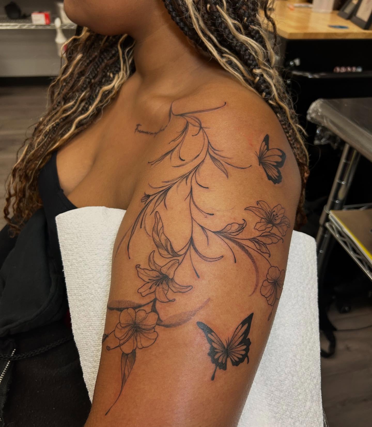 Flowers and butterflies black and grey tattoo on the shoulder by Livy baby