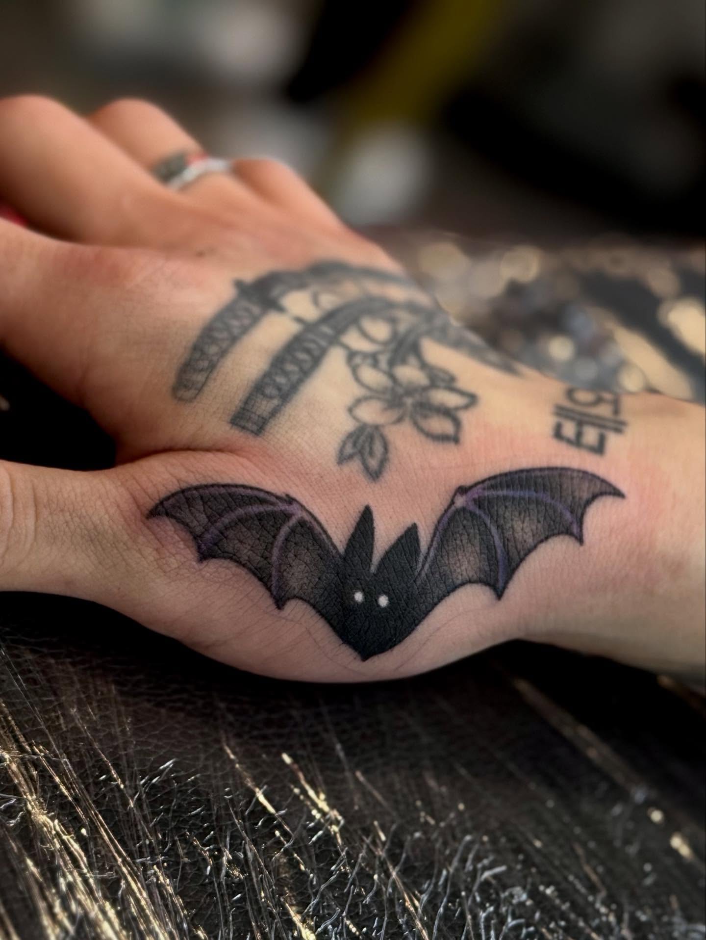 Bat black and grey tattoo on the hand by Ashley Kayser