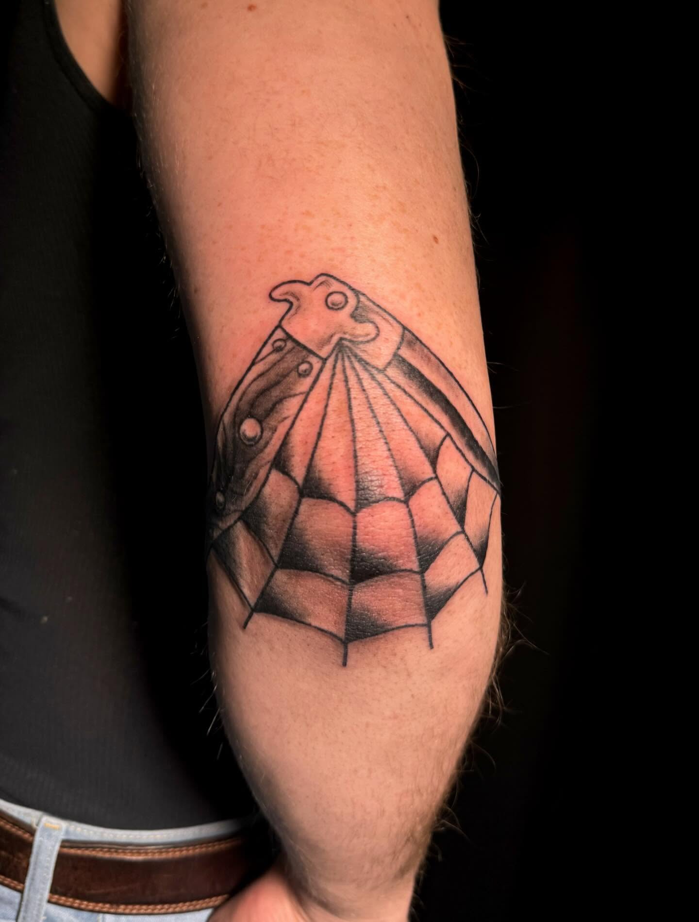 Spider web geometric tattoo on the forearm by Paris Romano