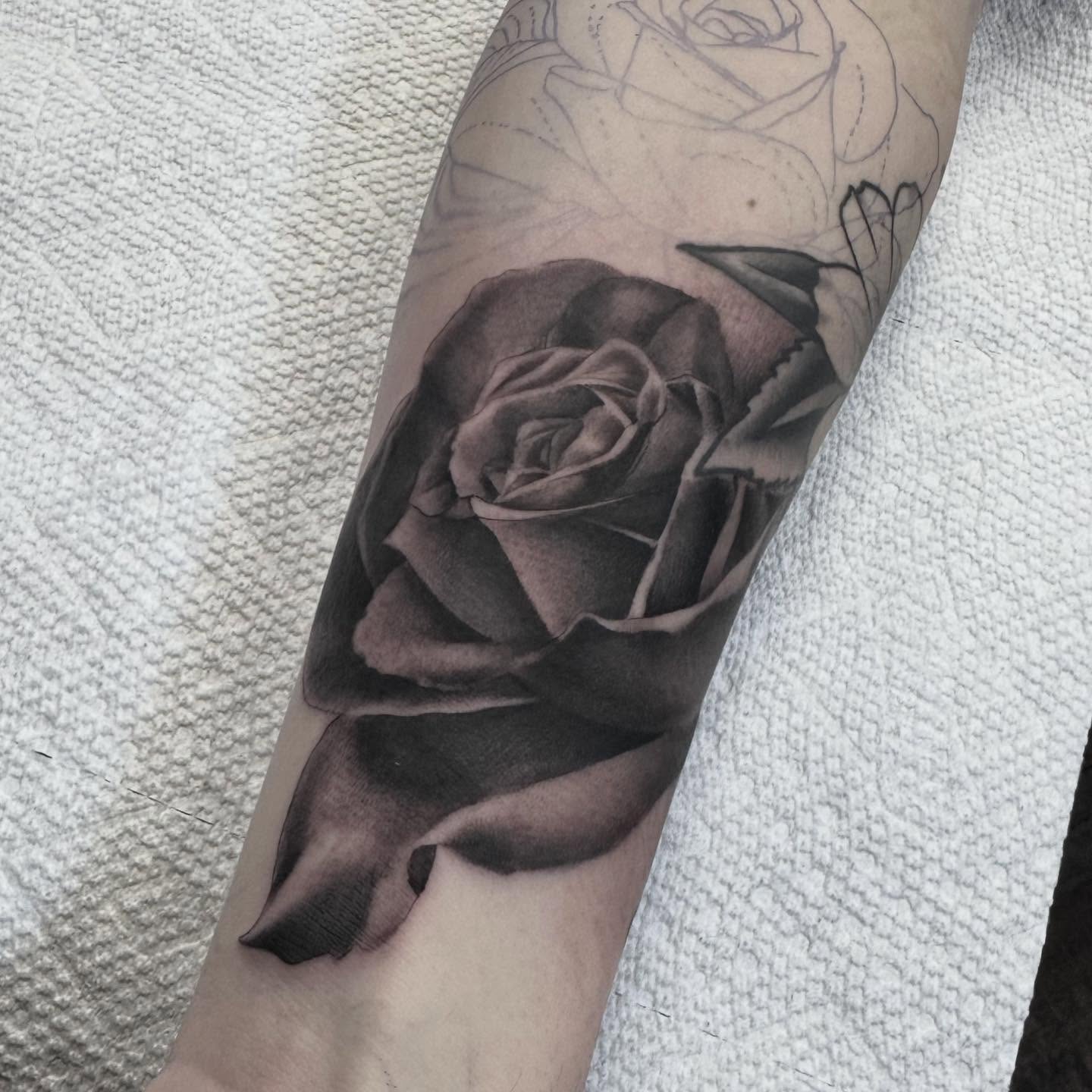 Rose realism tattoo on the forearm by Landon Lewis