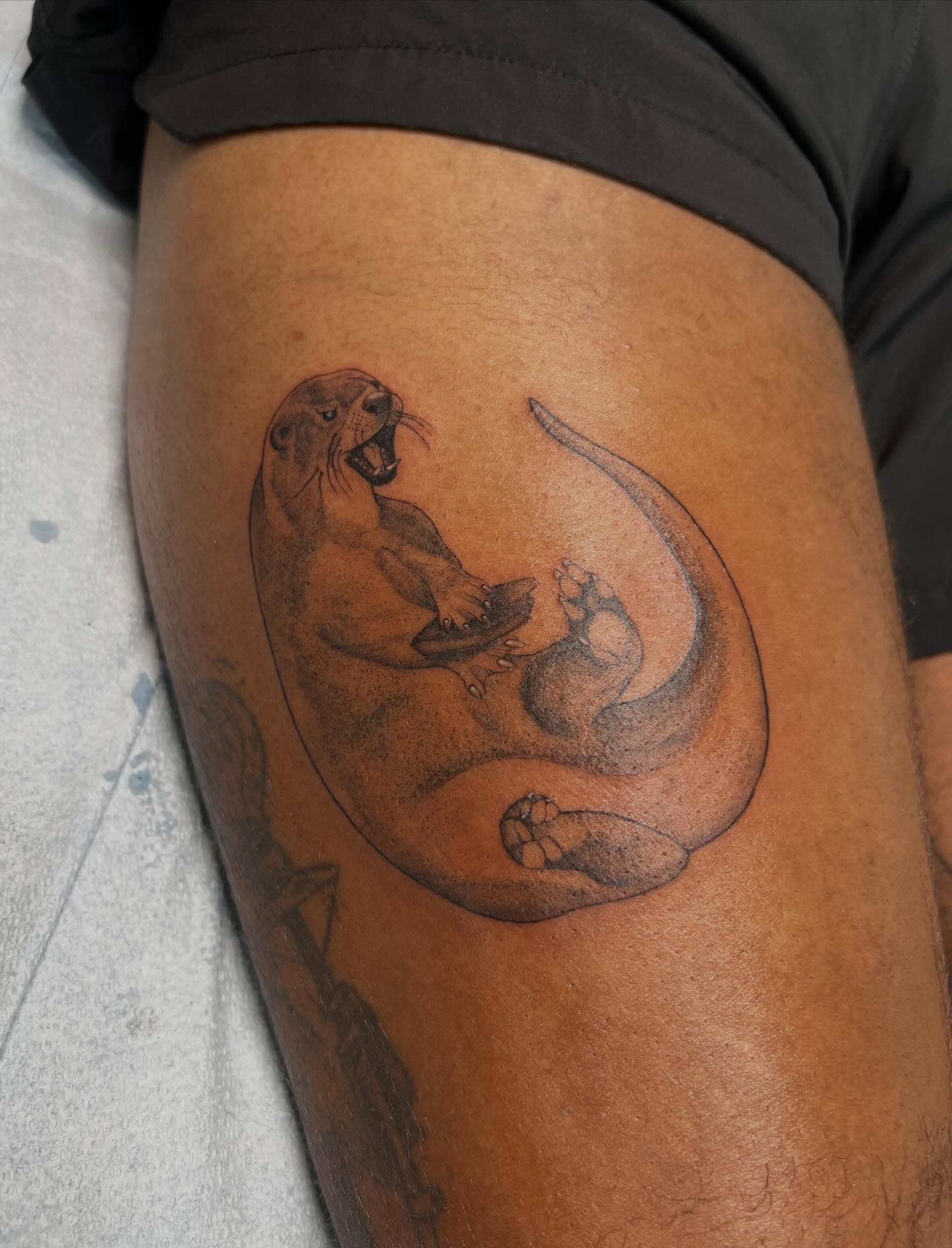 Sea otter realism tattoo on the thigh by sarah bug