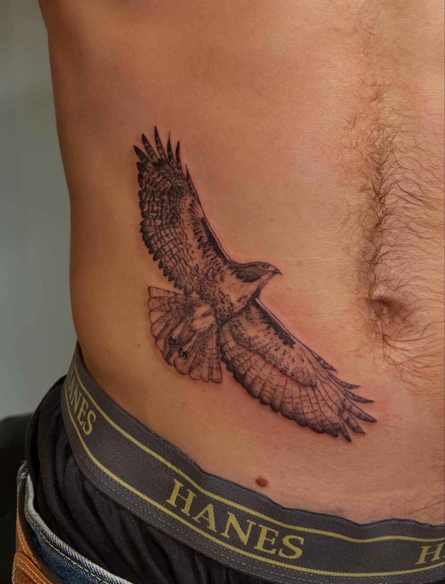 Hawk realism tattoo on the ribs by sarah bug