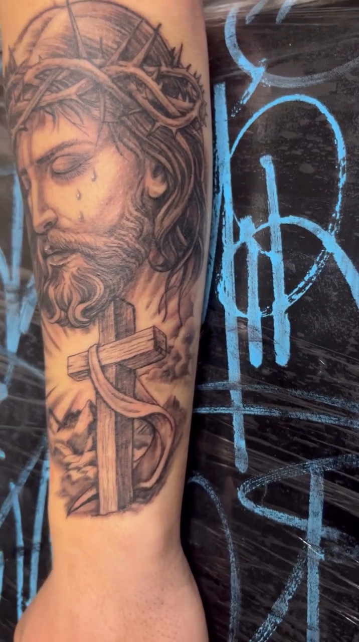 Jesus Christ portrait with cross realism tattoo by Look