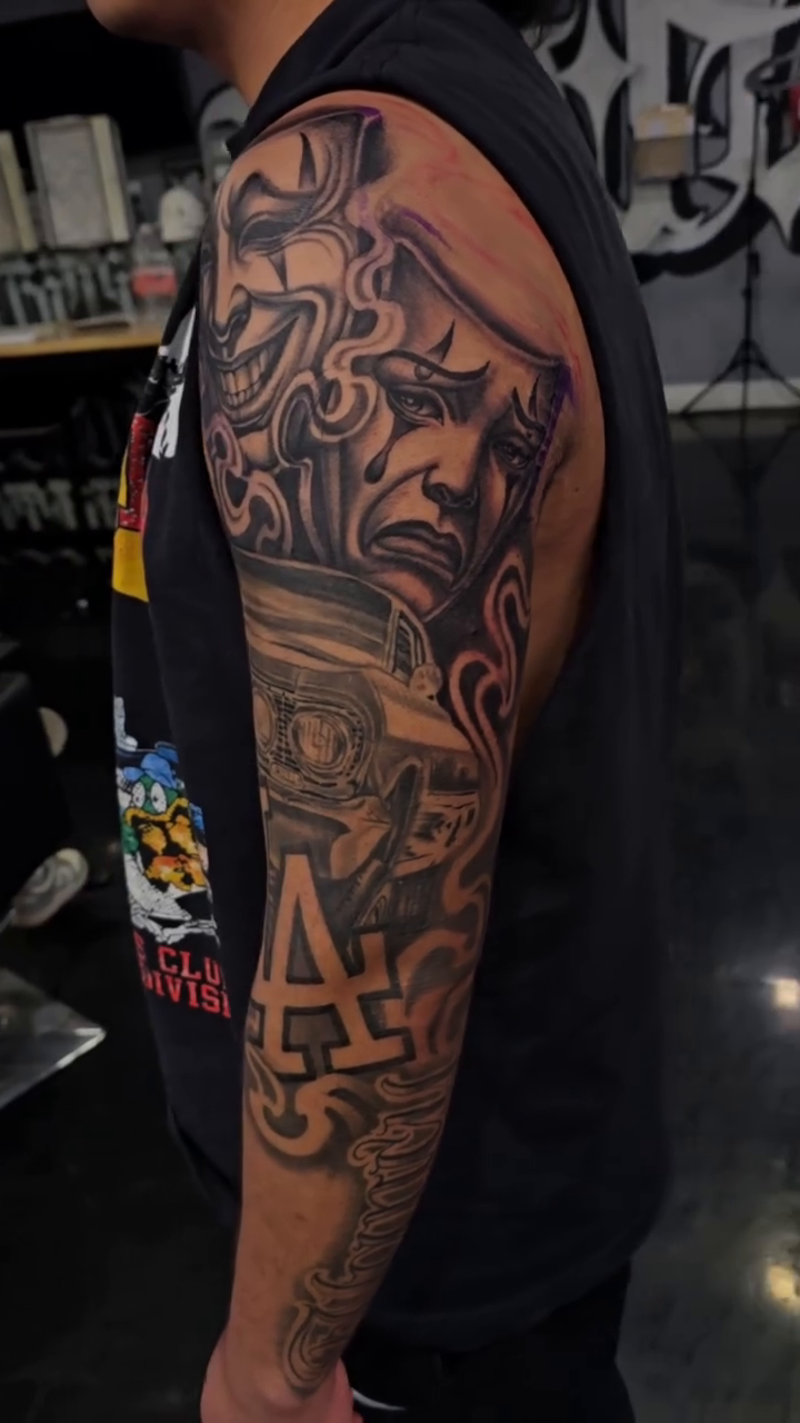Laughing mask and crying mask realism tattoo by Richie Garcia, Hesperia, California