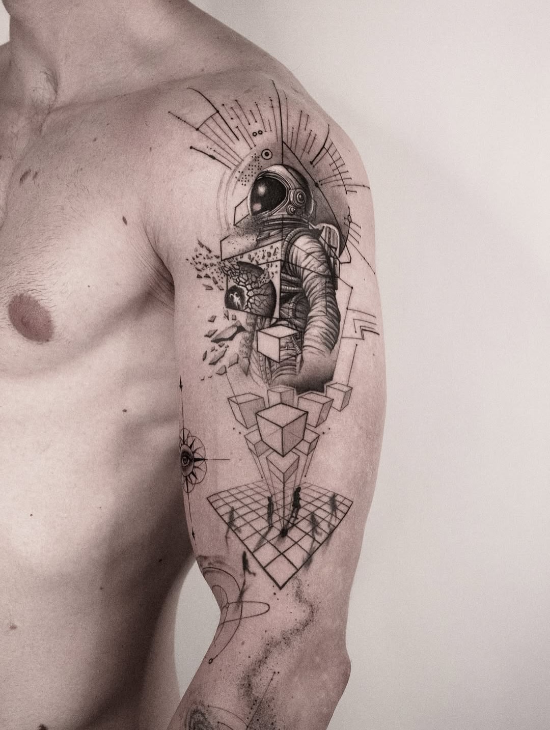 Astronaut geometric tattoo on the upper arm by János Bozóki, Budapest, Hungary
