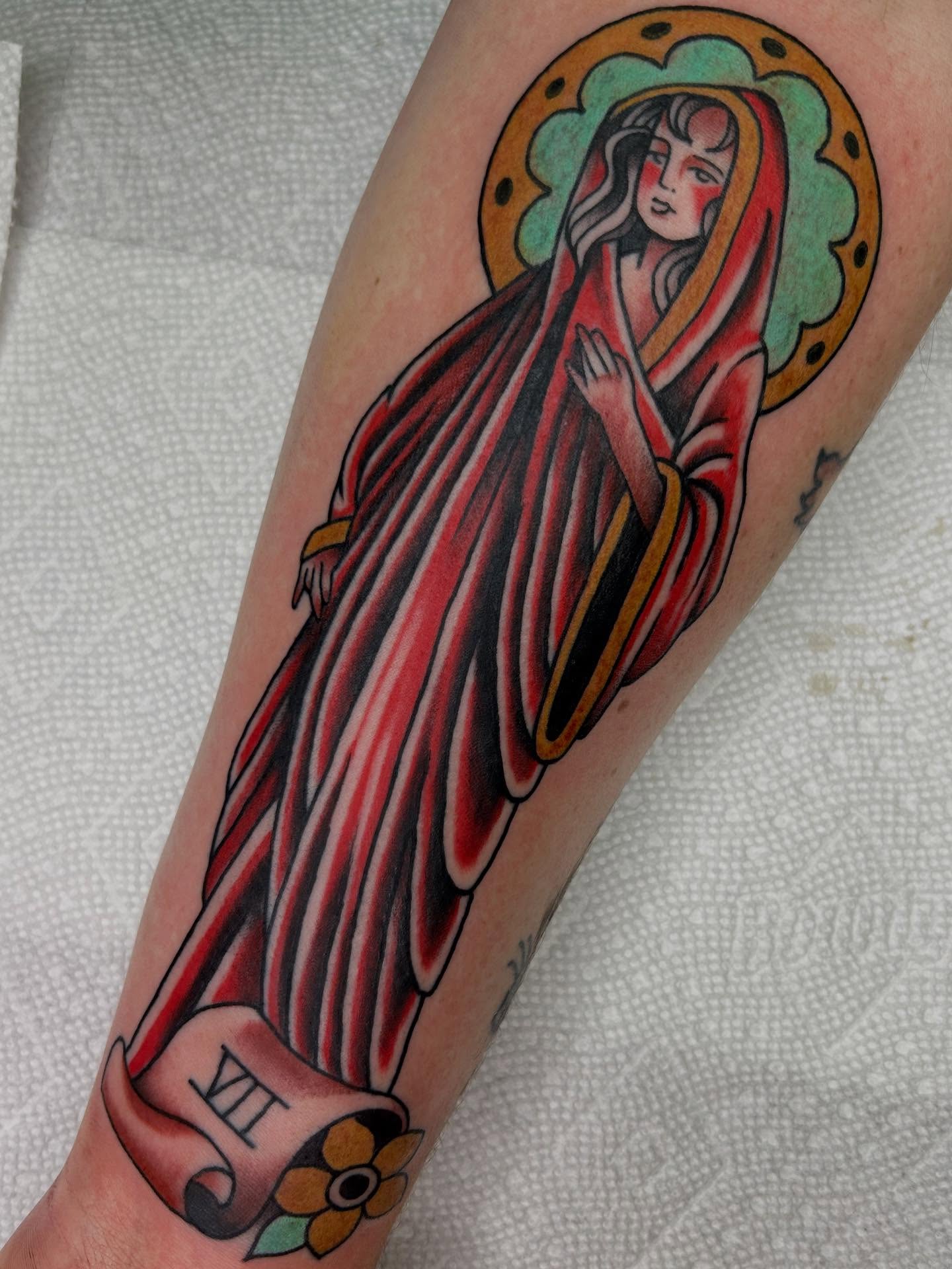 Religious figure American traditional tattoo on the forearm by Katie Dexter, Des Moines, Iowa