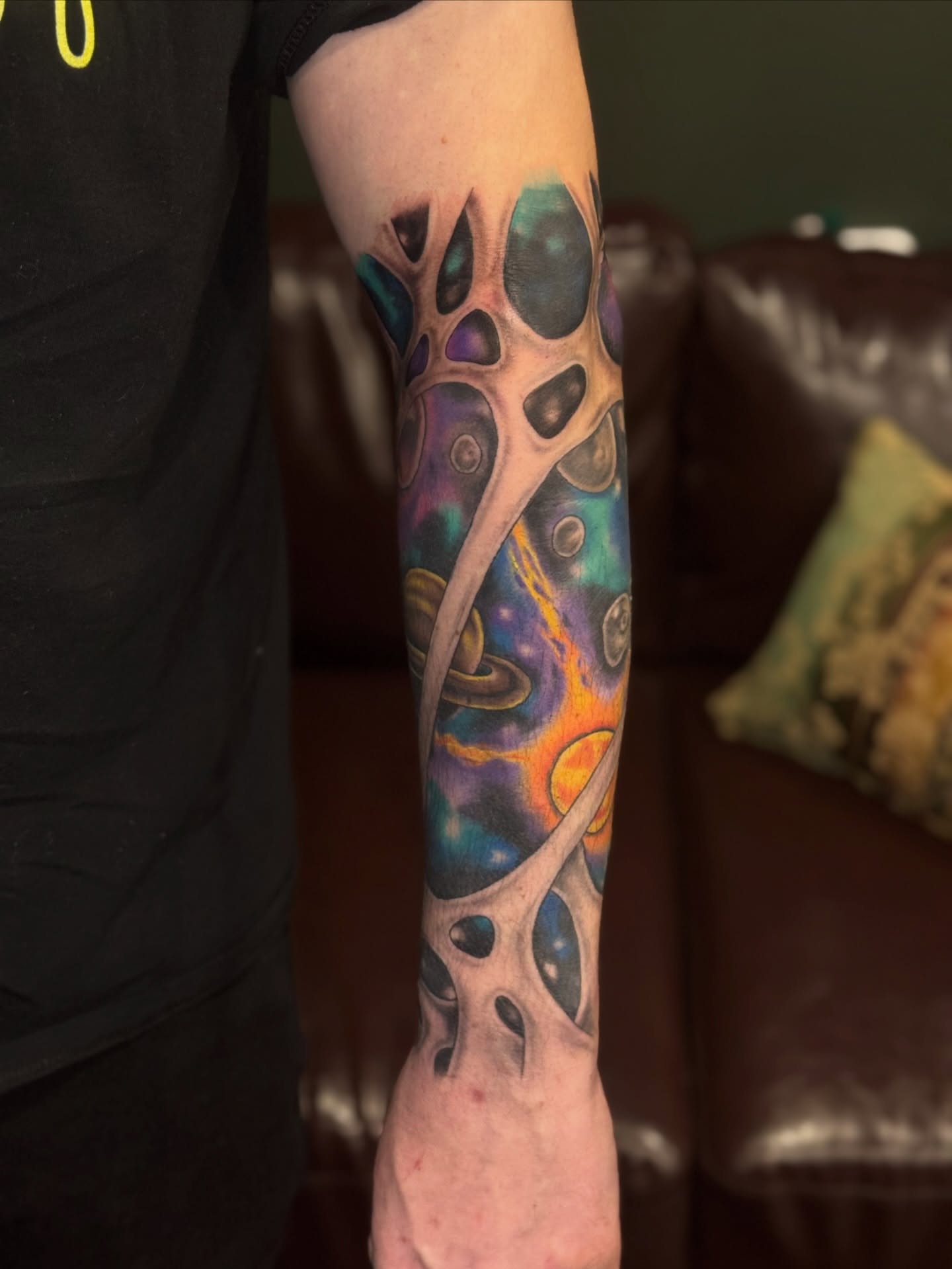 Galactic nebula surrealism tattoo on the forearm by Lily Nurnberger