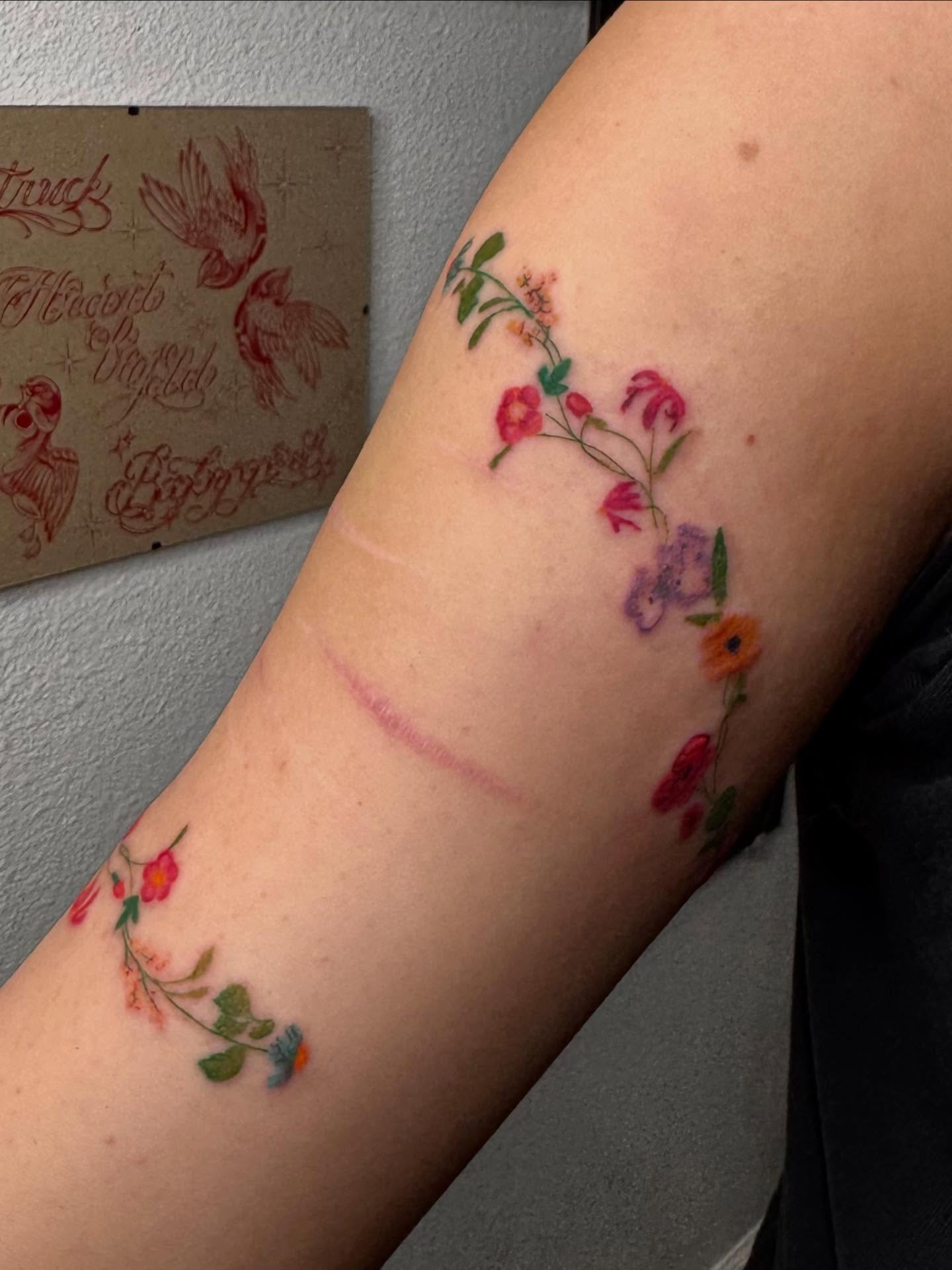 Floral arrangement watercolor tattoo on the forearm by Nat🫧