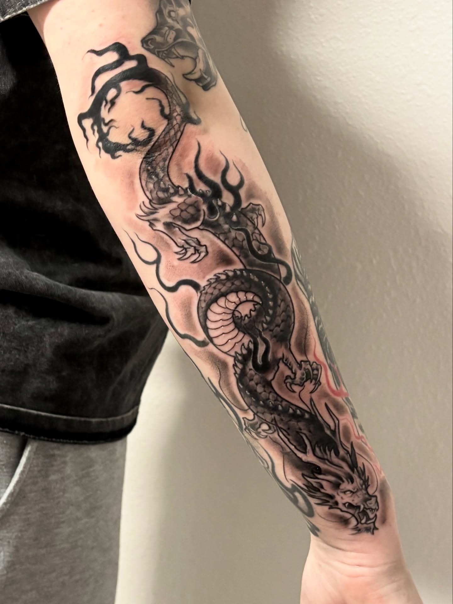 Dragon black and grey tattoo on the forearm by Elixabeth