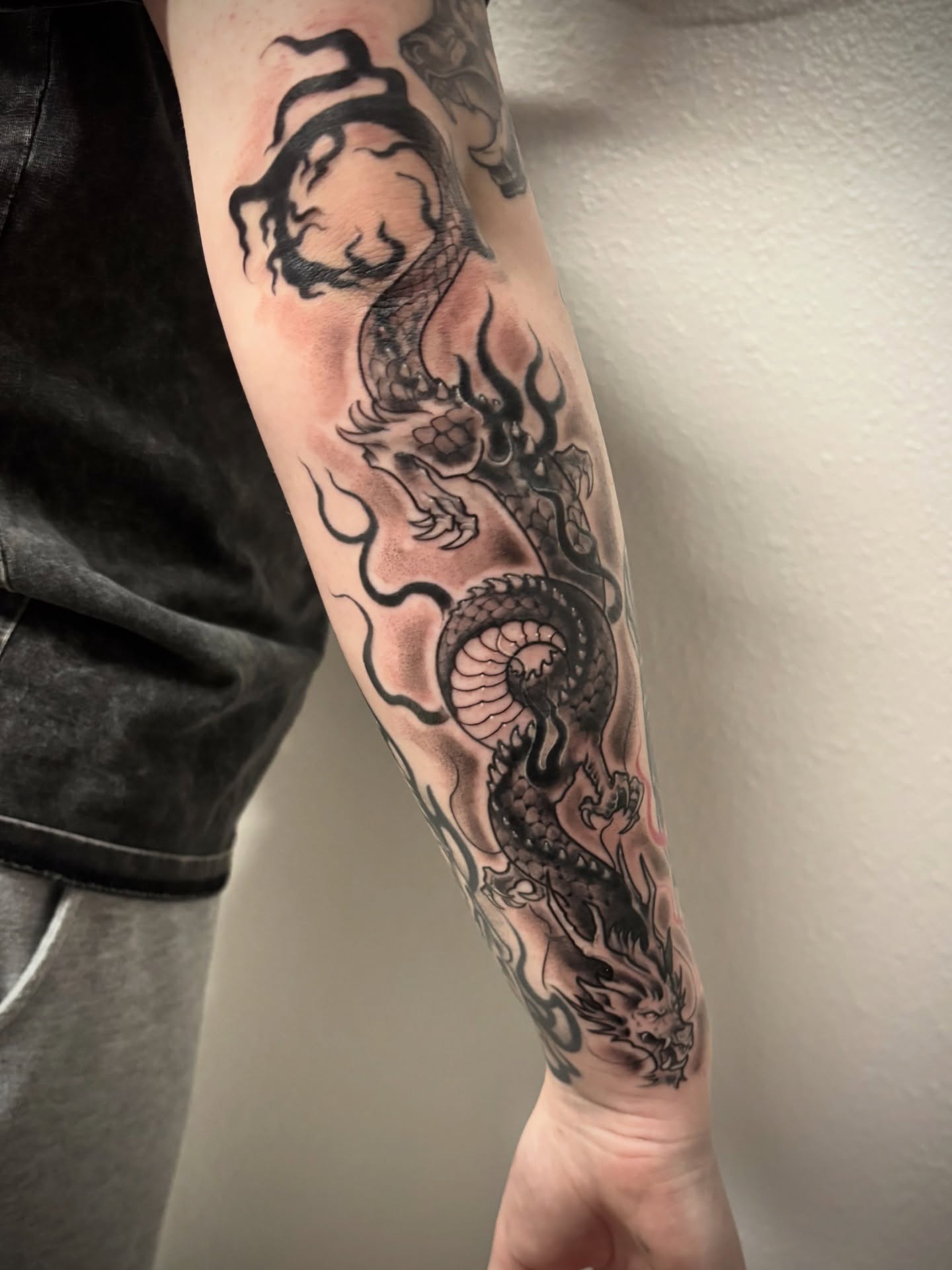 Dragon black and grey tattoo on the forearm by Elixabeth