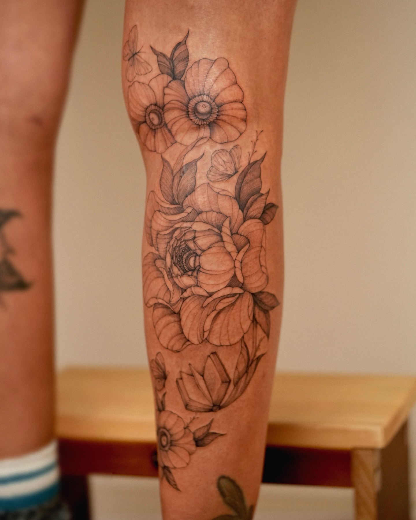 Floral bouquet black and grey tattoo on the forearm by Zalina Loriia