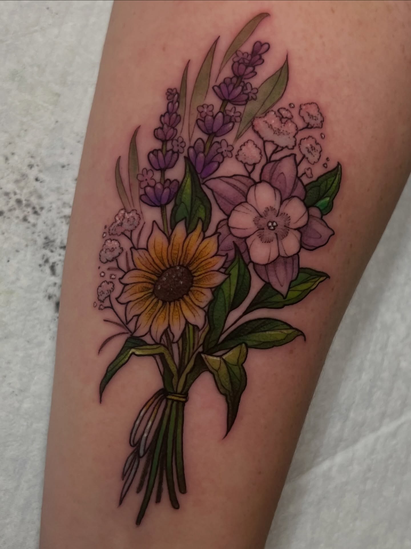 Bouquet of flowers watercolor tattoo on the forearm by Millie, Maryville, Tennessee