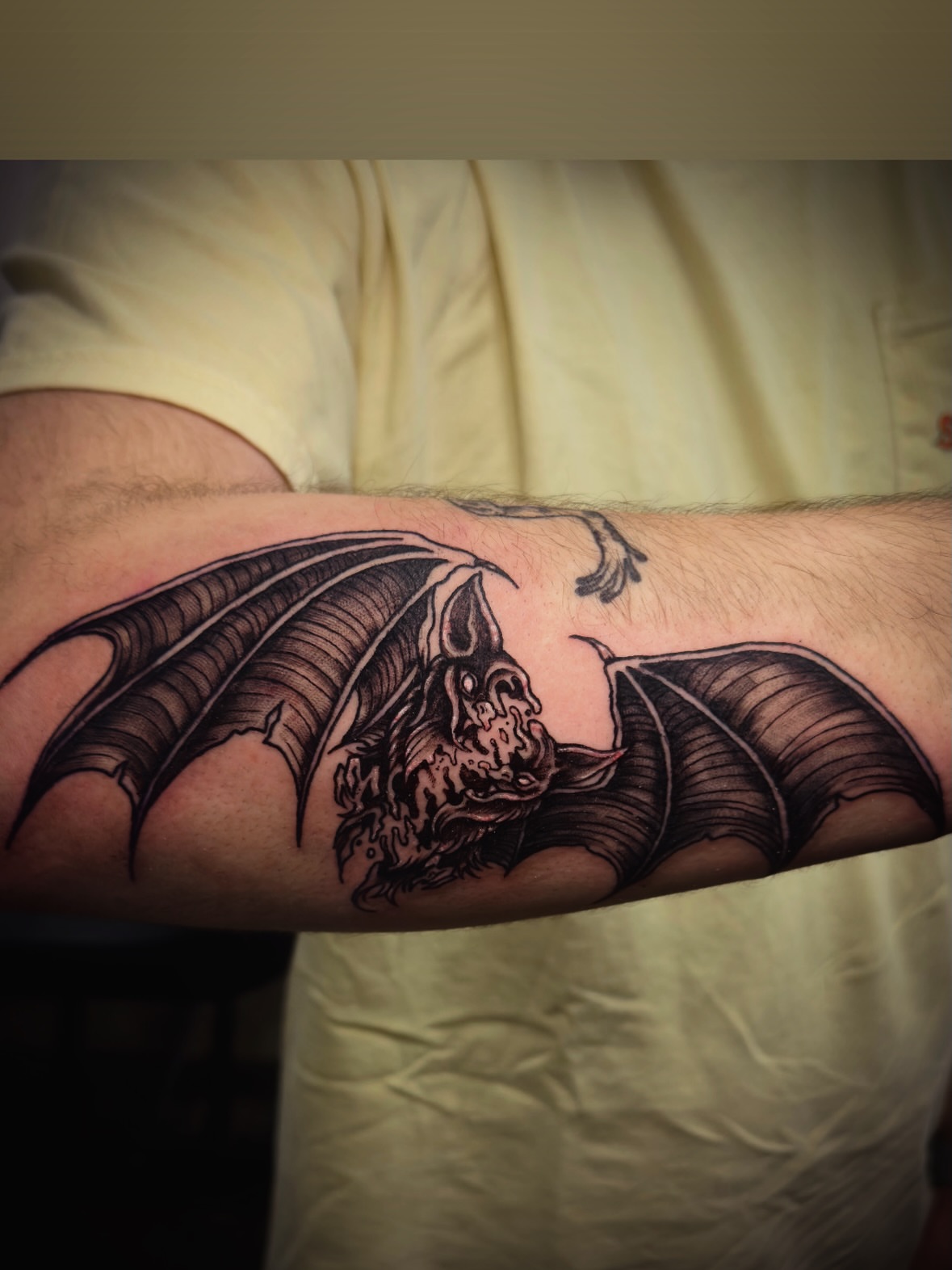 Bat black and grey tattoo on the forearm by Jeff Brock