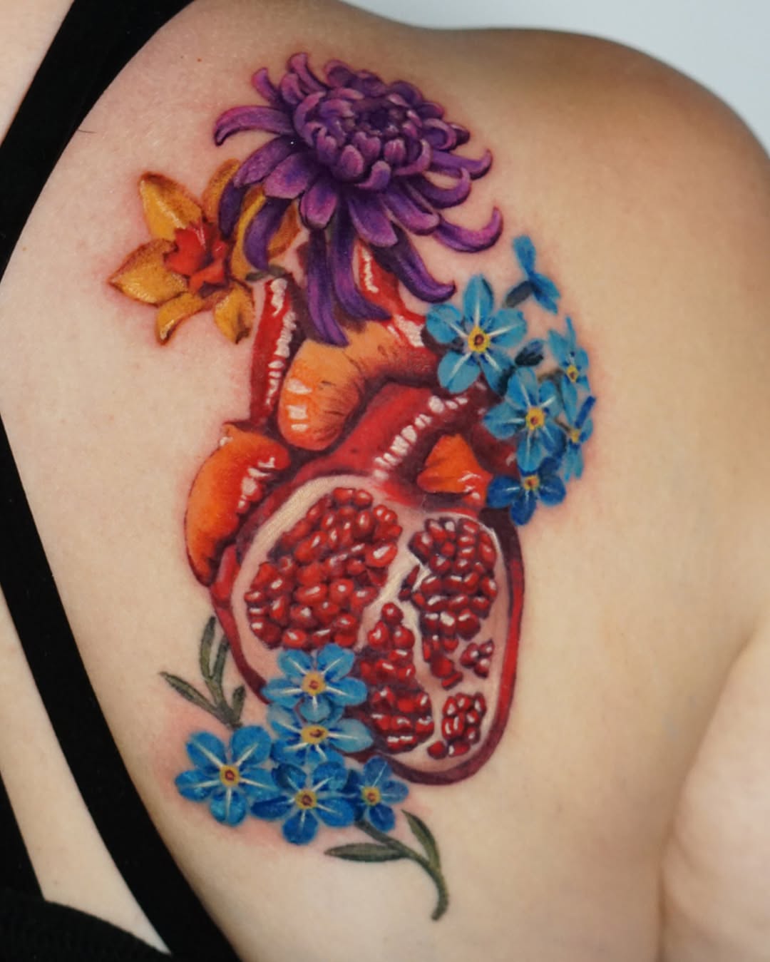 Heart with flowers realism tattoo on the shoulder by San Diego Color Realism and Neotraditional