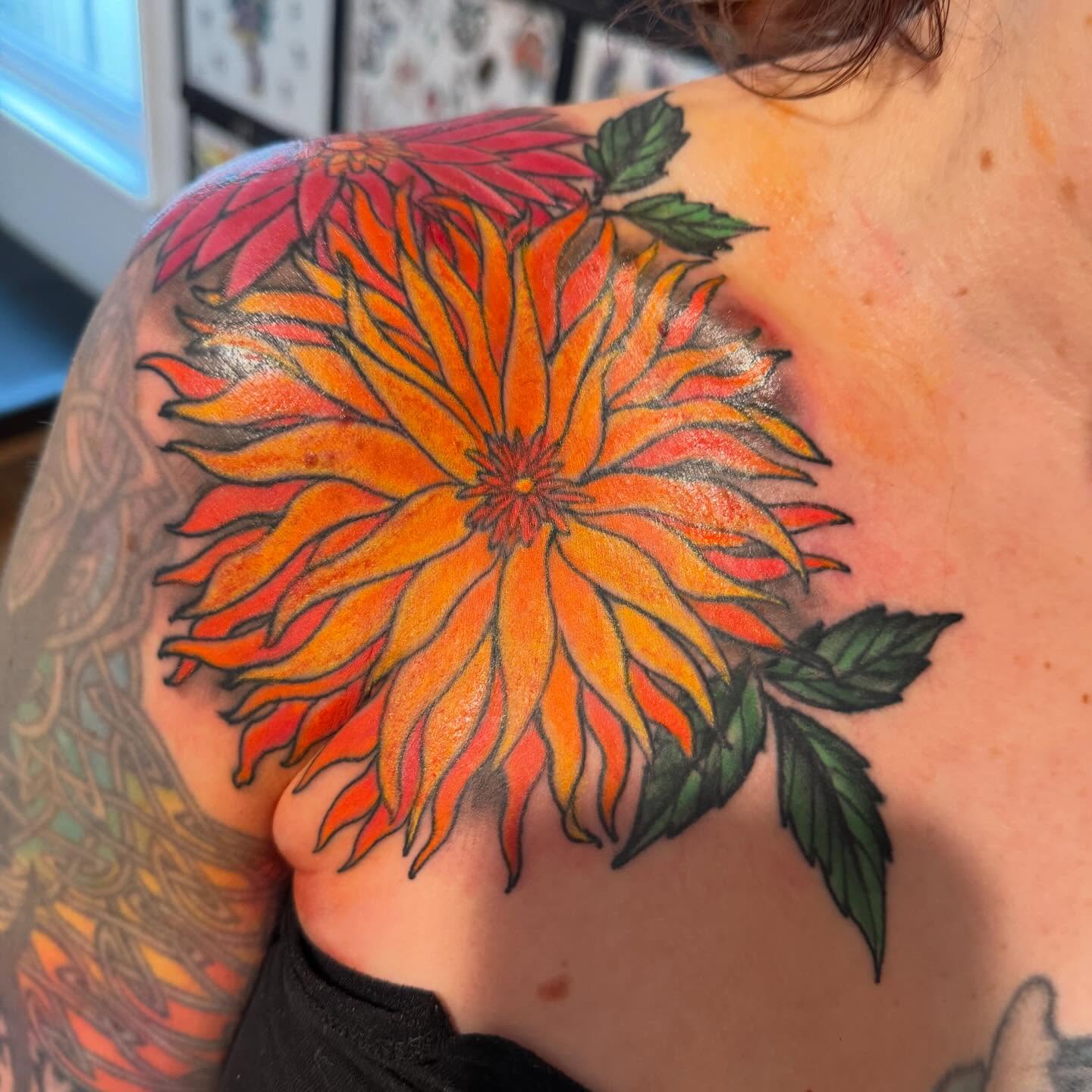 Dahlia flower watercolor tattoo on the shoulder by Laura Saadati Kepper