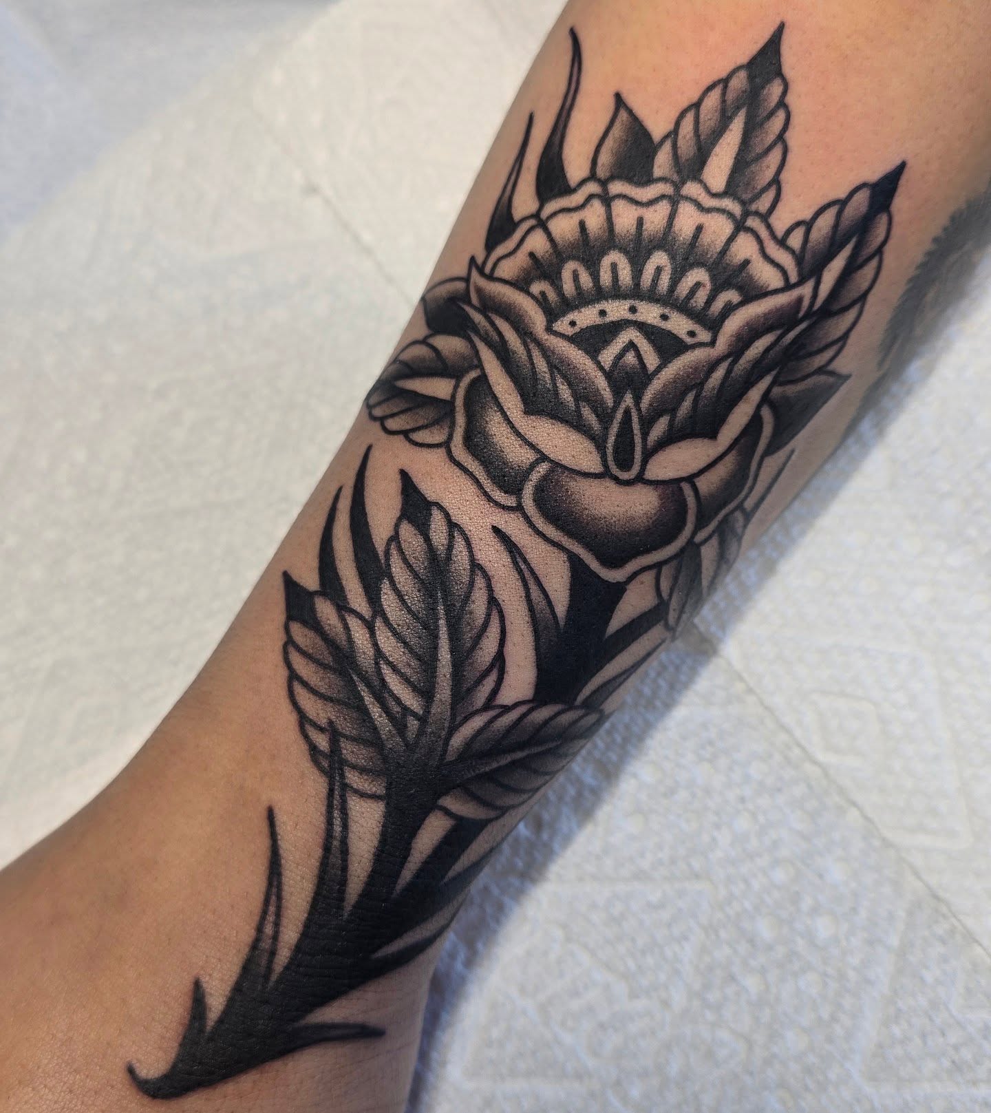 Floral design American traditional tattoo on the forearm by A. Teixeira, Los Angeles, California