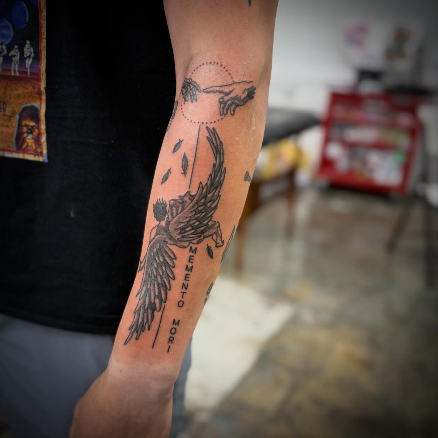 Angelic figure black and grey tattoo on the forearm by Devin
