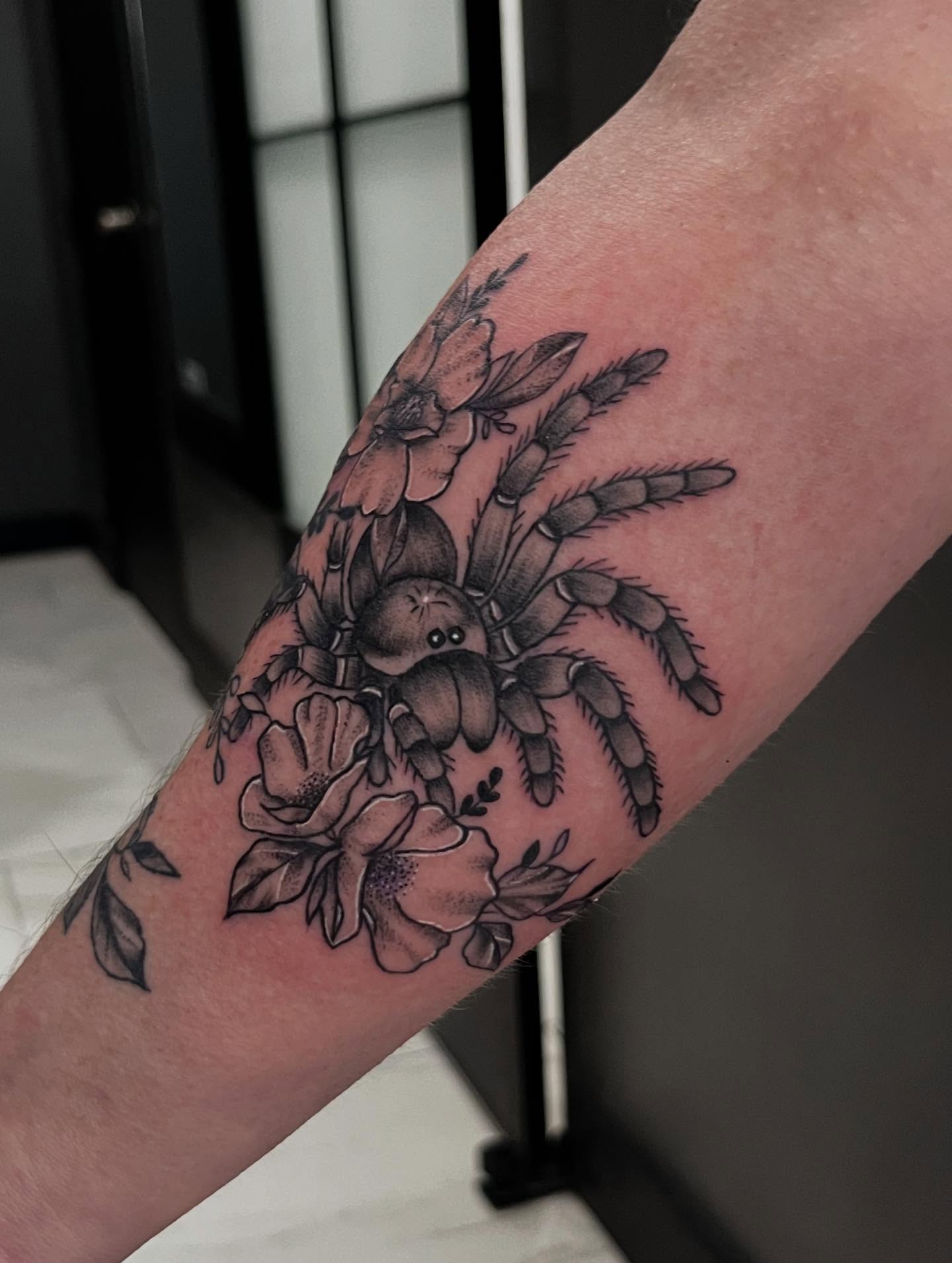 Spider and flowers black and grey tattoo on the forearm by Lexi Odam