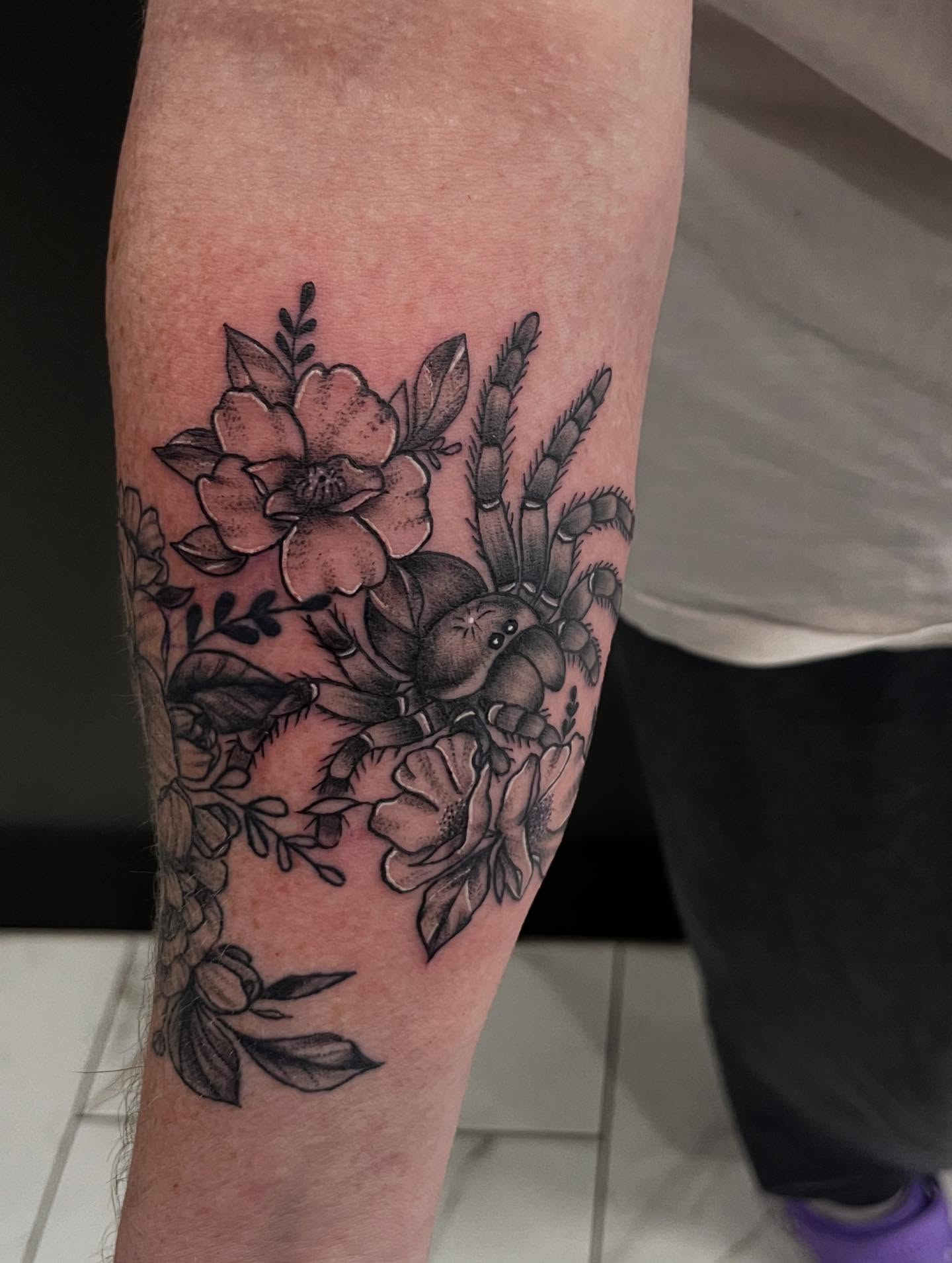 Floral bouquet black and grey tattoo on the forearm by Lexi Odam