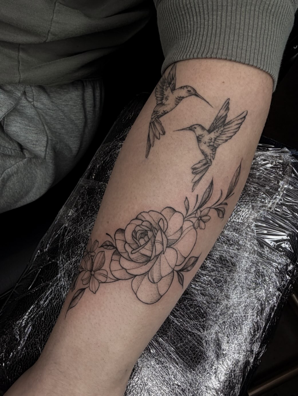 Hummingbirds and roses realism tattoo on the forearm by Susie Maj
