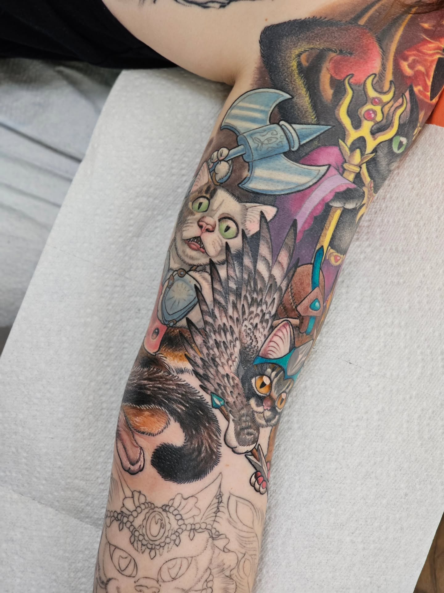 Cats and fantasy elements American traditional tattoo on the forearm by Bellz Rehder
